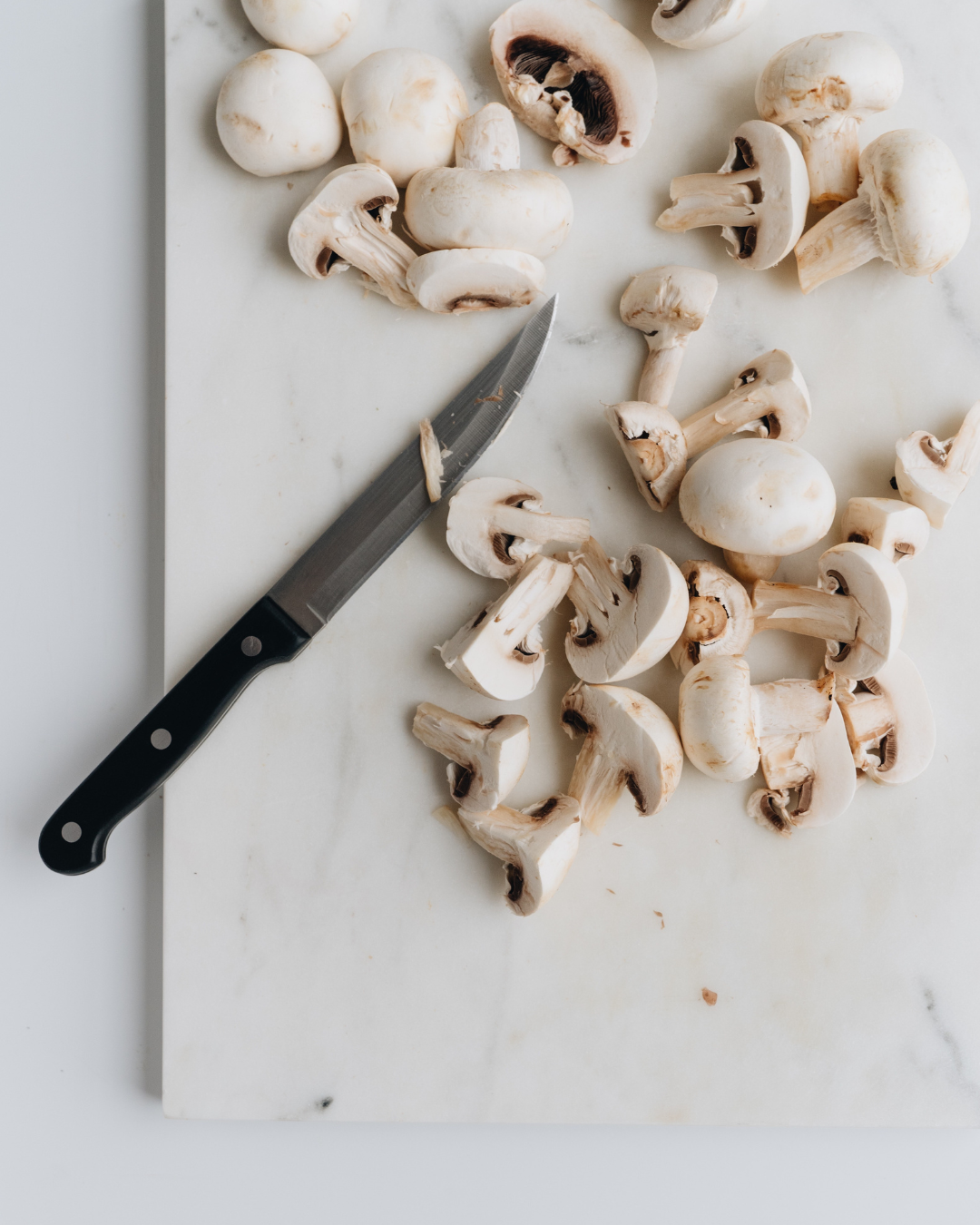 mushroom soup ingredients - mushrooms on cutting board.png