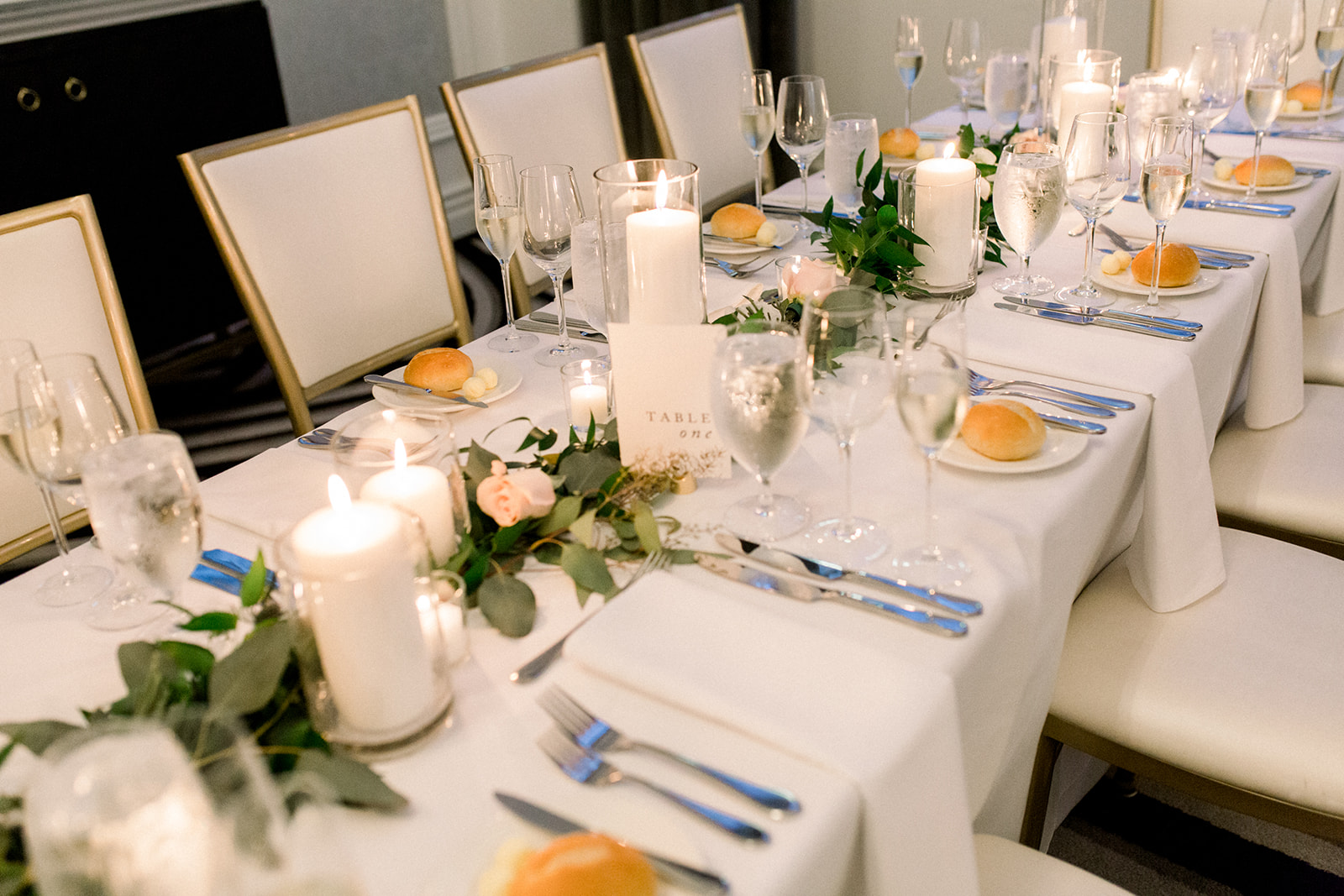 Wedding centerpieces with greenery and gold accents for Pittsburgh wedding held at Hotel Monaco. See more beautiful details of this simple, yet stunning wedding at exhale-events.com!