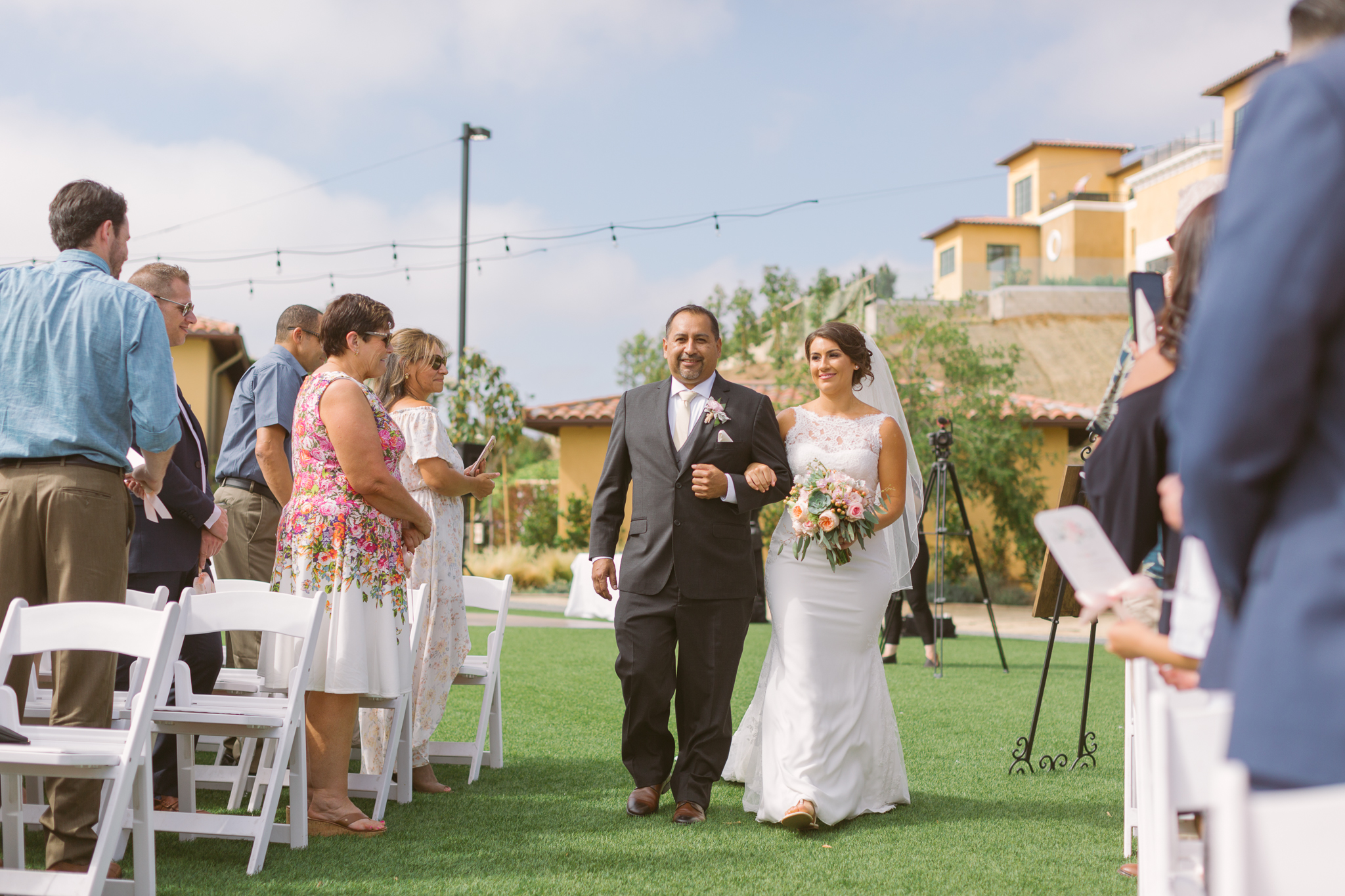 Bride walking down the aisle at San Diego, California outdoor wedding planned by Exhale Events. See all the beautiful details at exhale-events.com!