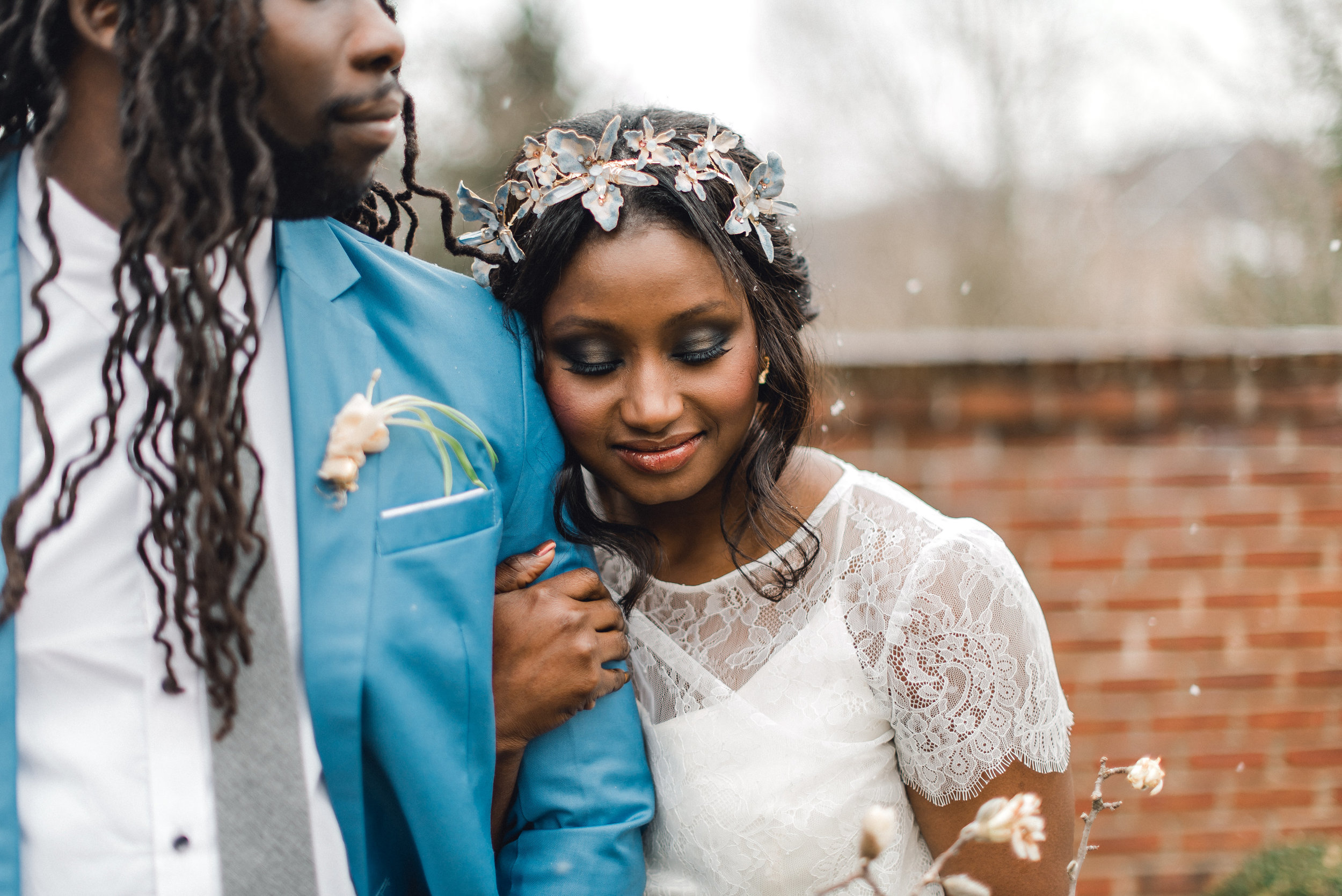 Bride and groom pose for outdoor wedding photos as it snows at wedding venue for Pablo Neruda enchanting garden styled shoot planned by Exhale Events. Get inspired at exhale-events.com!