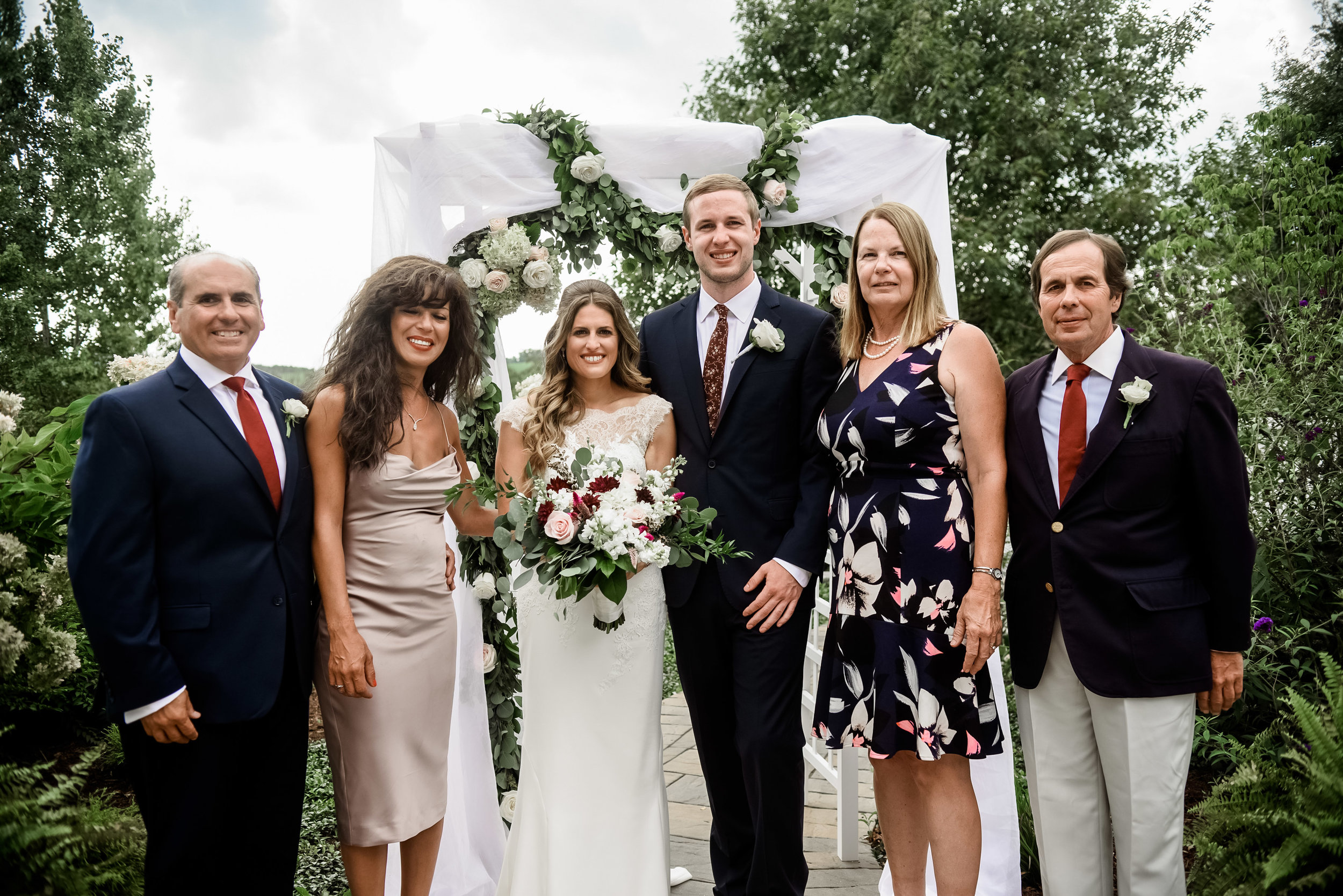 Bride and groom pose for outdoor wedding photos with family at Pittsburgh wedding planned by Exhale Events. Find more wedding inspiration at exhale-events.com!
