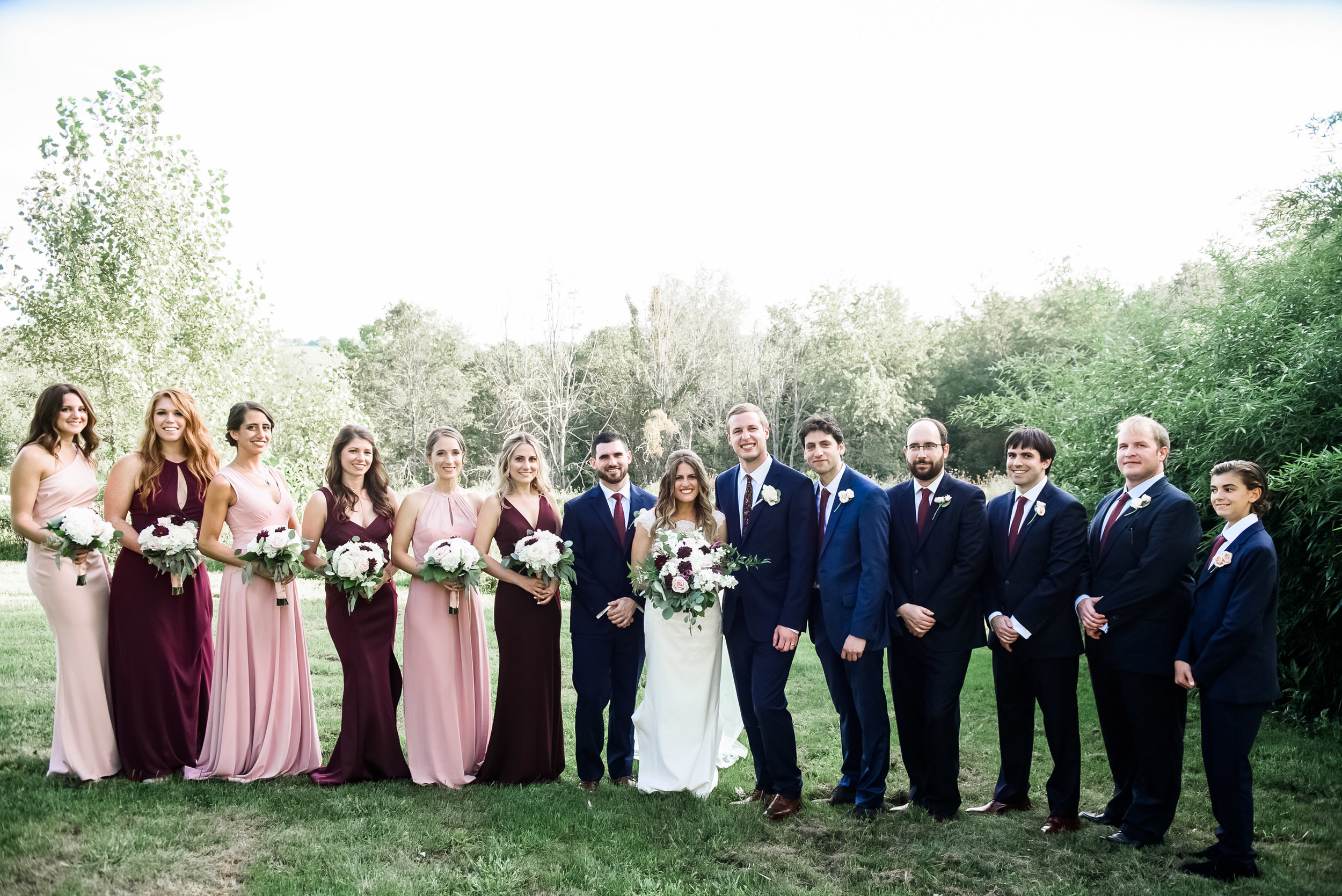 Bride and groom pose for wedding photos with wedding party at Pittsburgh wedding planned by Exhale Events. Find more wedding inspiration at exhale-events.com!
