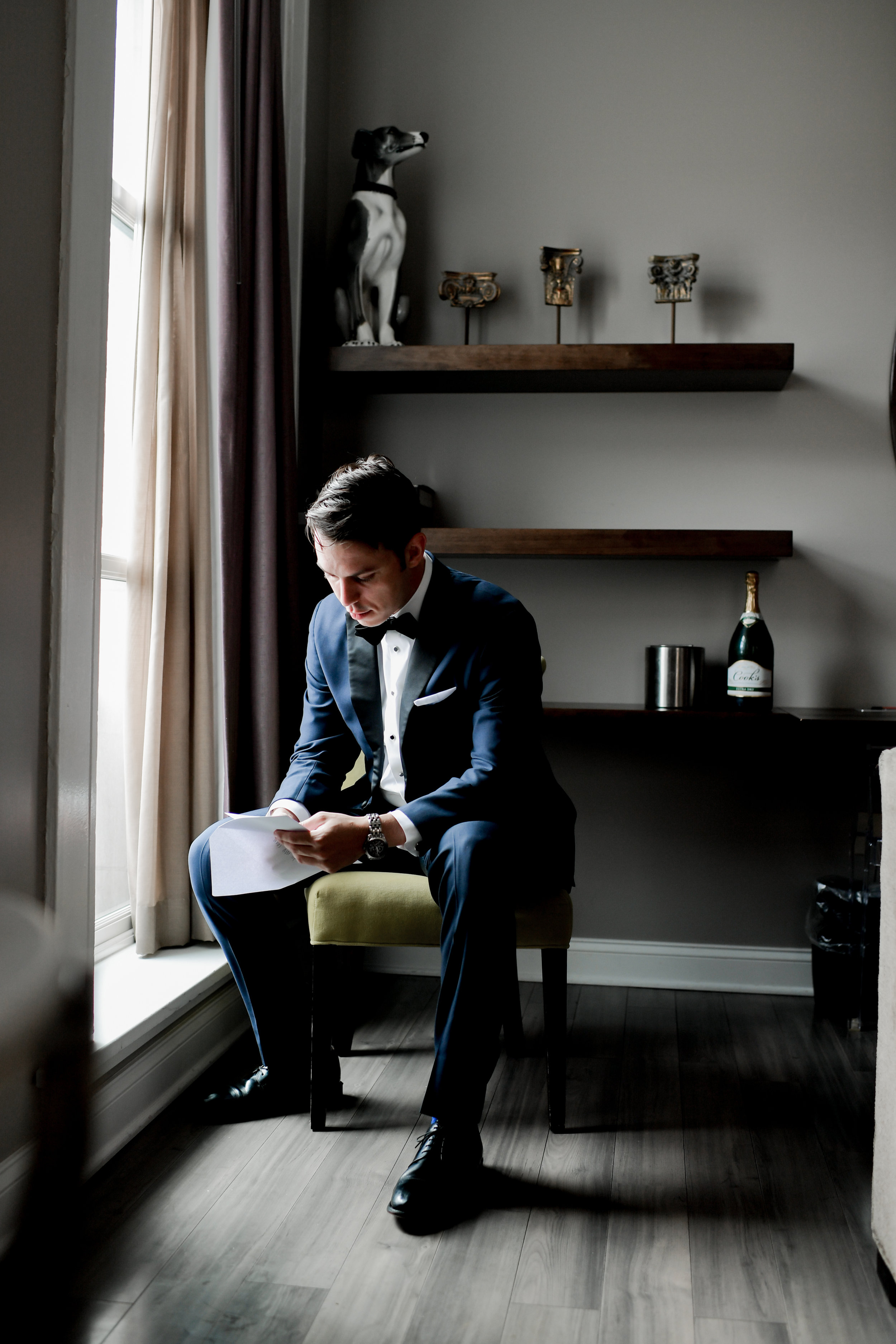 Groom reading letter from bride for Buffalo, NY wedding planned by Exhale Events. Find more wedding inspiration at exhale-events.com!