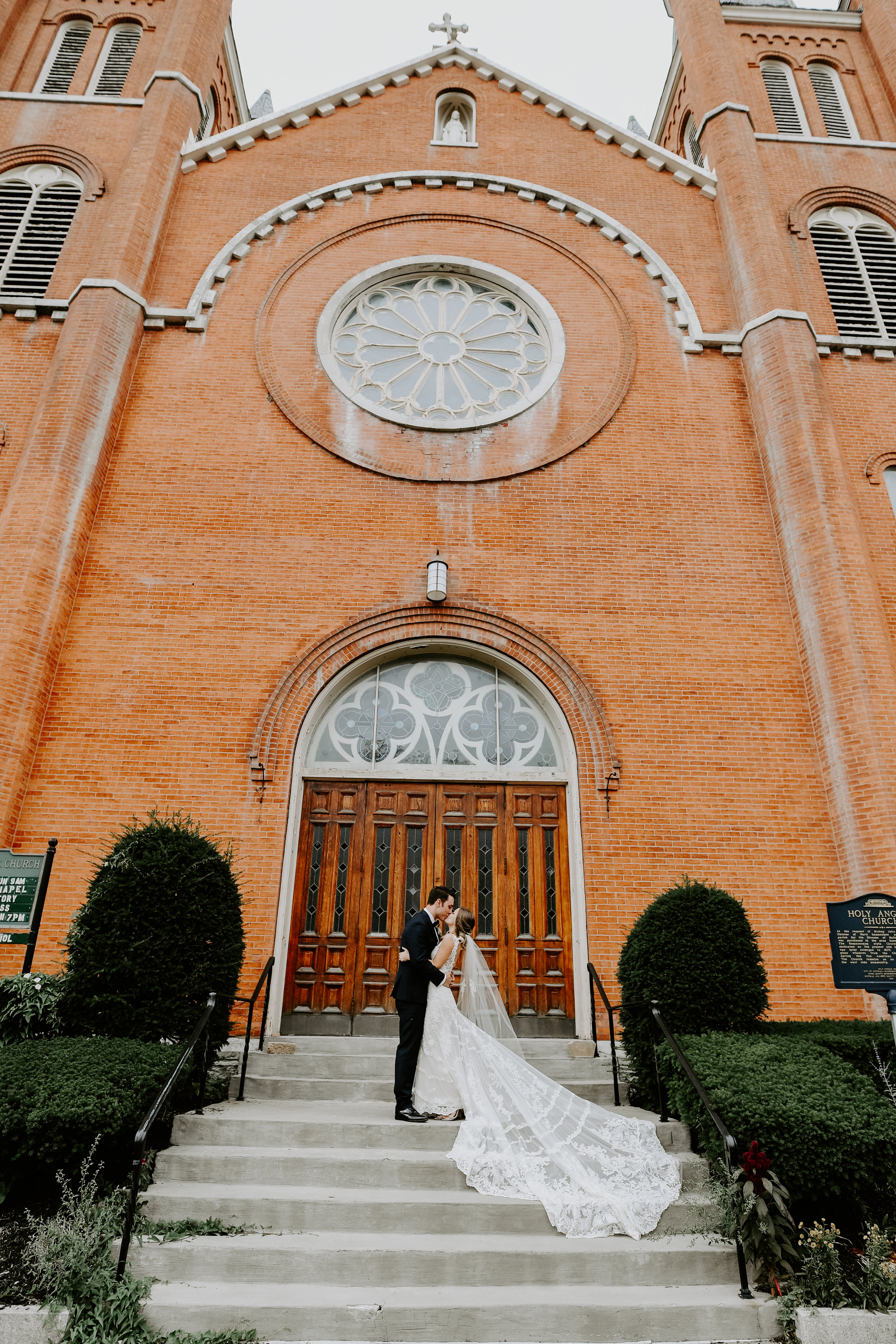 Bride and groom pose for wedding pictures outside wedding ceremony at Buffalo, NY wedding planned by Exhale Events. Find more wedding inspiration at exhale-events.com!
