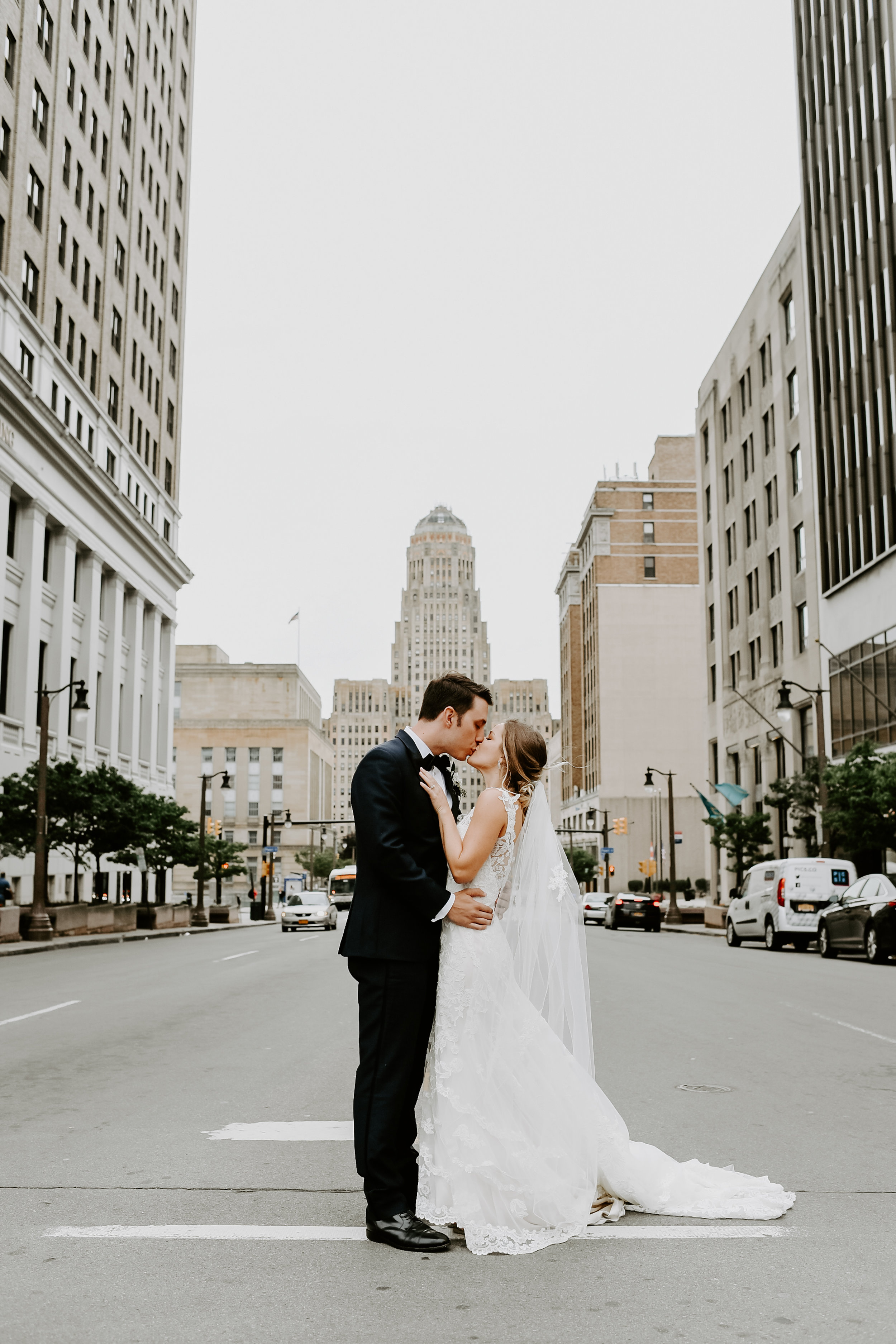 Bride and groom pose for wedding pictures outside at Buffalo, NY wedding planned by Exhale Events. Find more wedding inspiration at exhale-events.com!