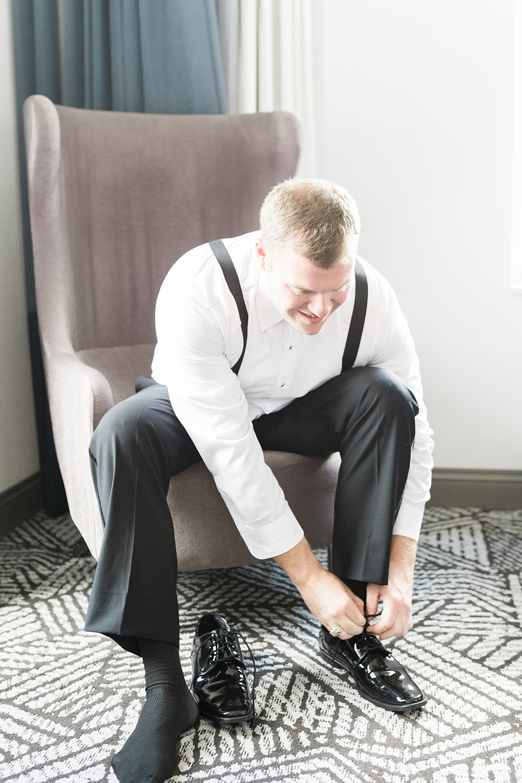Groom getting ready in black tuxedo and bow tie for Pittsburgh wedding at PNC Park planned by Exhale Events. Find more wedding inspiration at exhale-events.com!