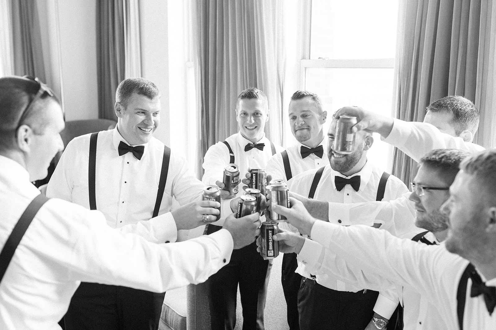 Groom and groomsmen getting ready in black tuxedos and bow ties for Pittsburgh wedding at PNC Park planned by Exhale Events. Find more wedding inspiration at exhale-events.com!