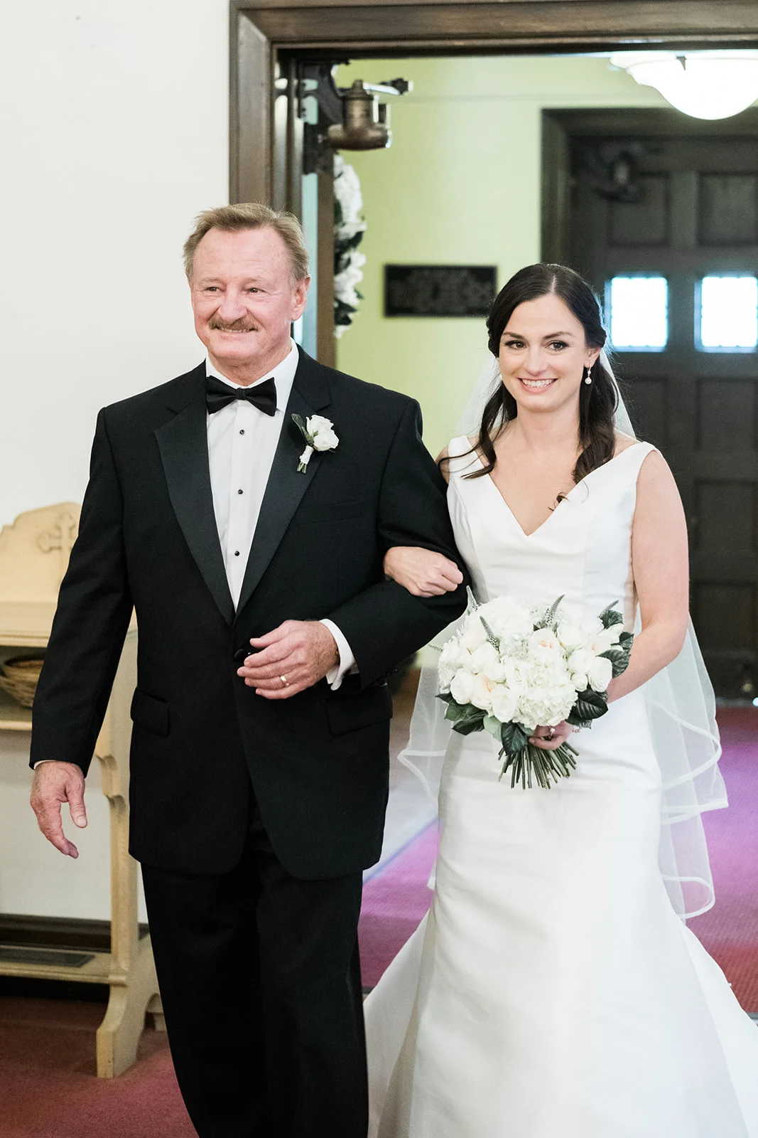 Bride and her father walk down the aisle at the wedding ceremony at Pittsburgh wedding at PNC Park planned by Exhale Events. Find more wedding inspiration at exhale-events.com!
