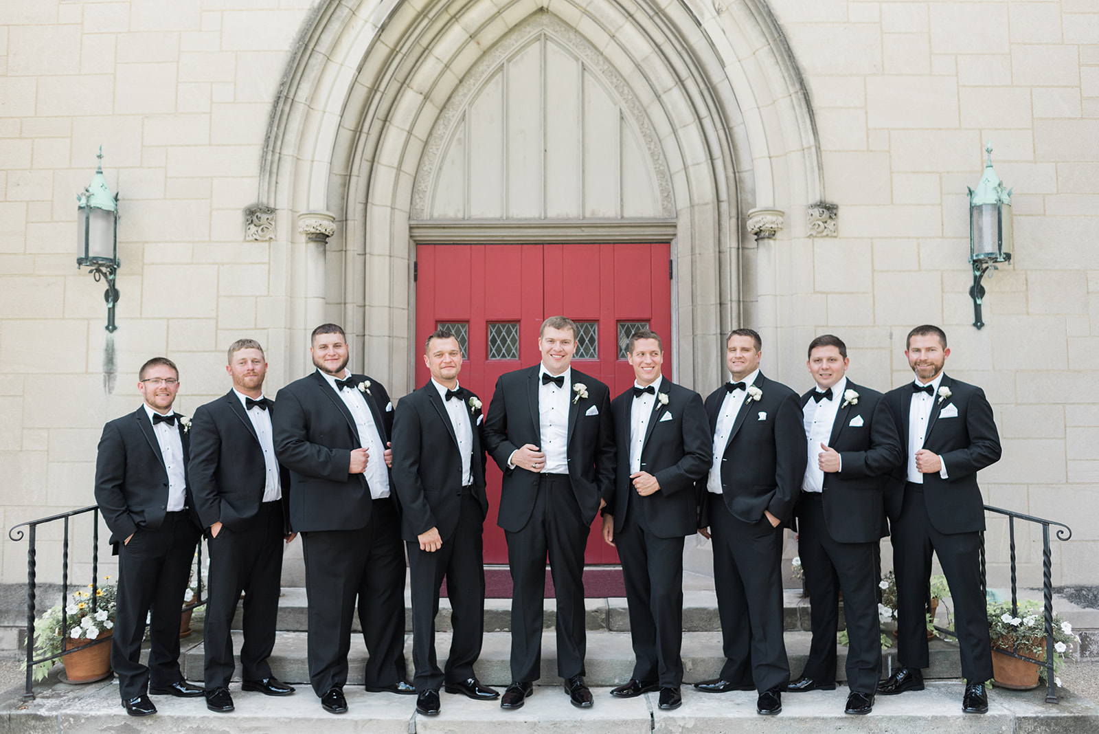 Groom and groomsmen pose for wedding photos in black tuxedos for Pittsburgh wedding at PNC Park planned by Exhale Events. Find more wedding inspiration at exhale-events.com!