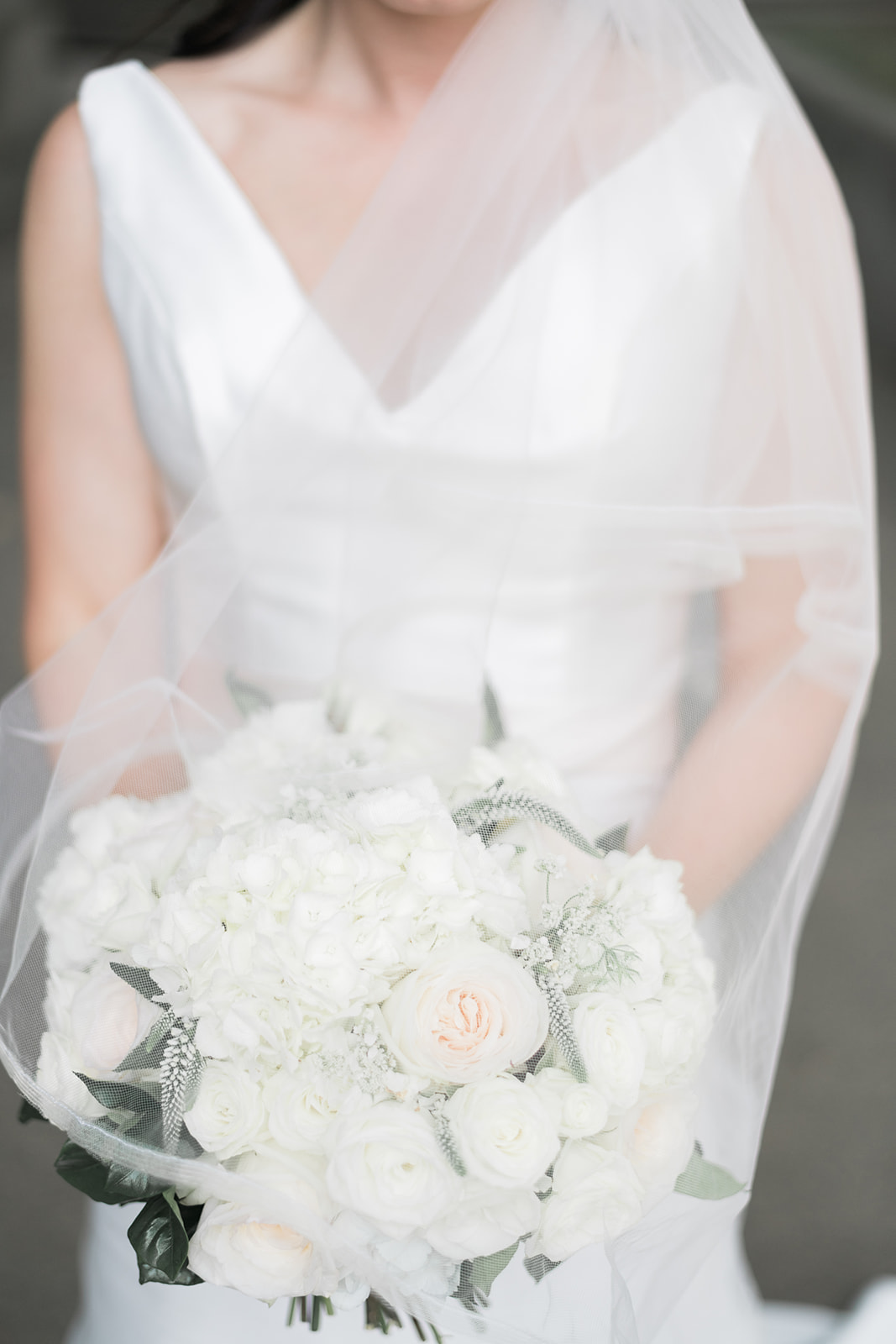Bride holding white wedding bouquet for Pittsburgh wedding at PNC Park planned by Exhale Events. Find more wedding inspiration at exhale-events.com!