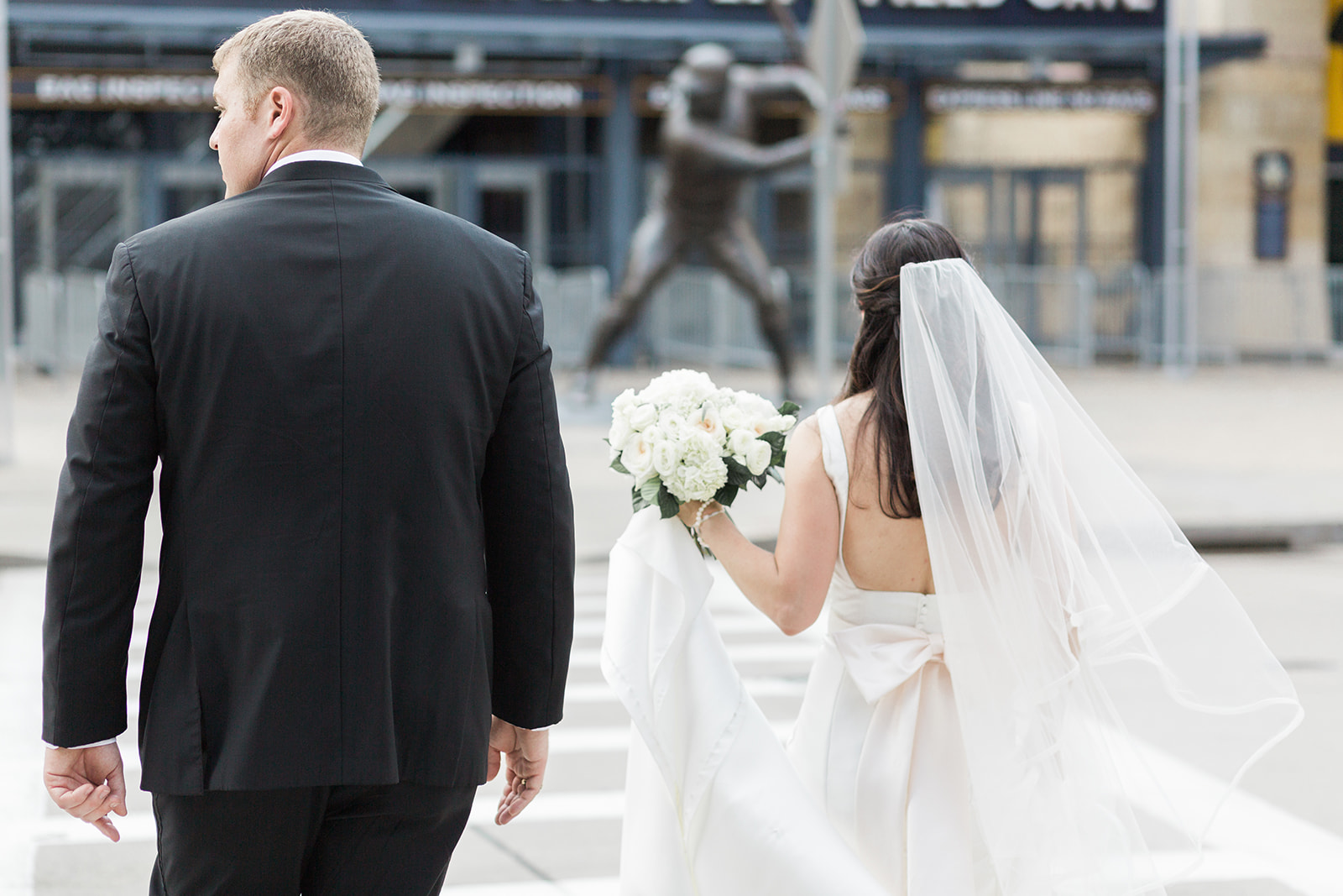 Bride and groom pose for wedding photos for Pittsburgh wedding at PNC Park planned by Exhale Events. Find more wedding inspiration at exhale-events.com!