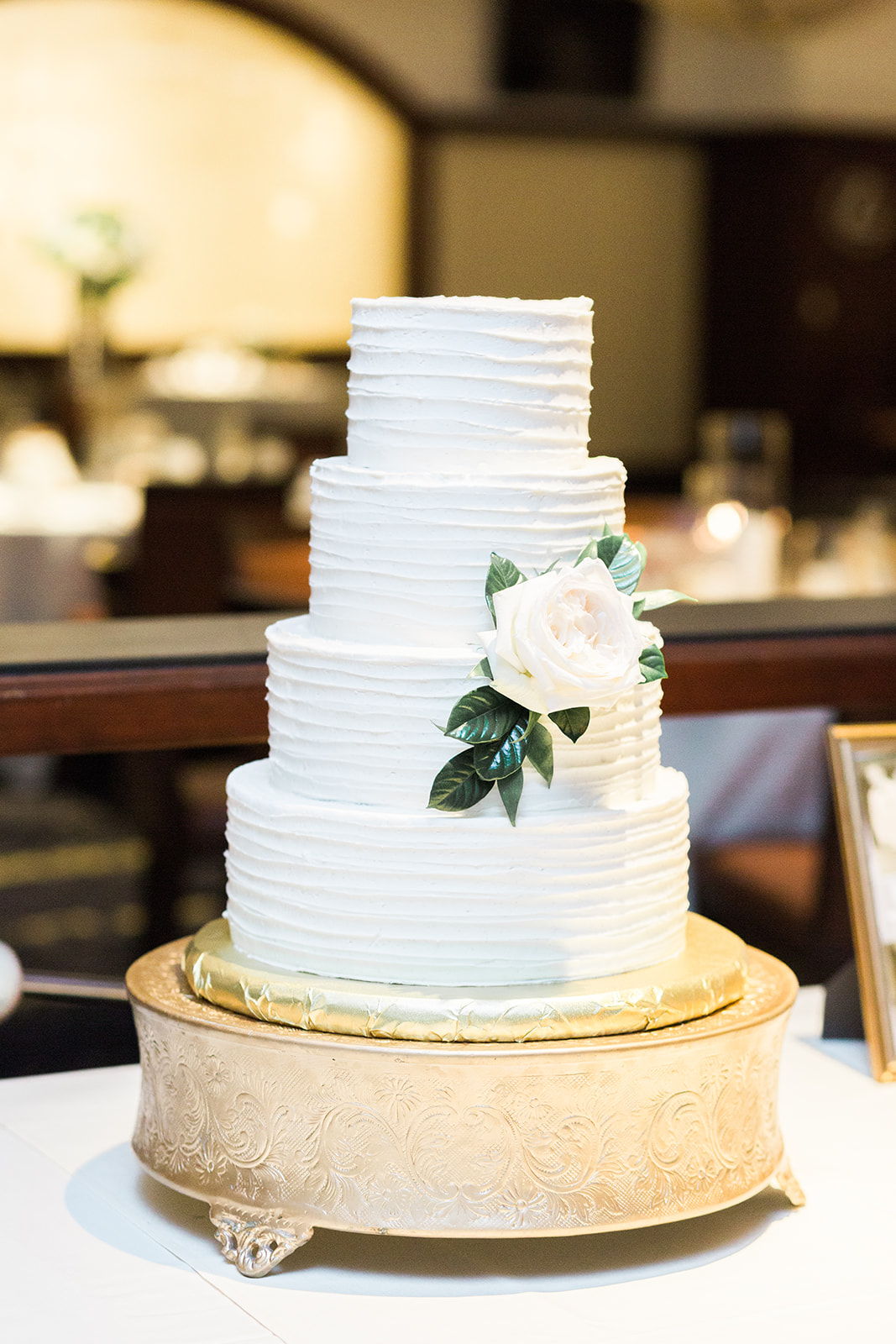 Simple wedding cake design with a flower for Pittsburgh wedding at PNC Park planned by Exhale Events. Find more wedding inspiration at exhale-events.com!