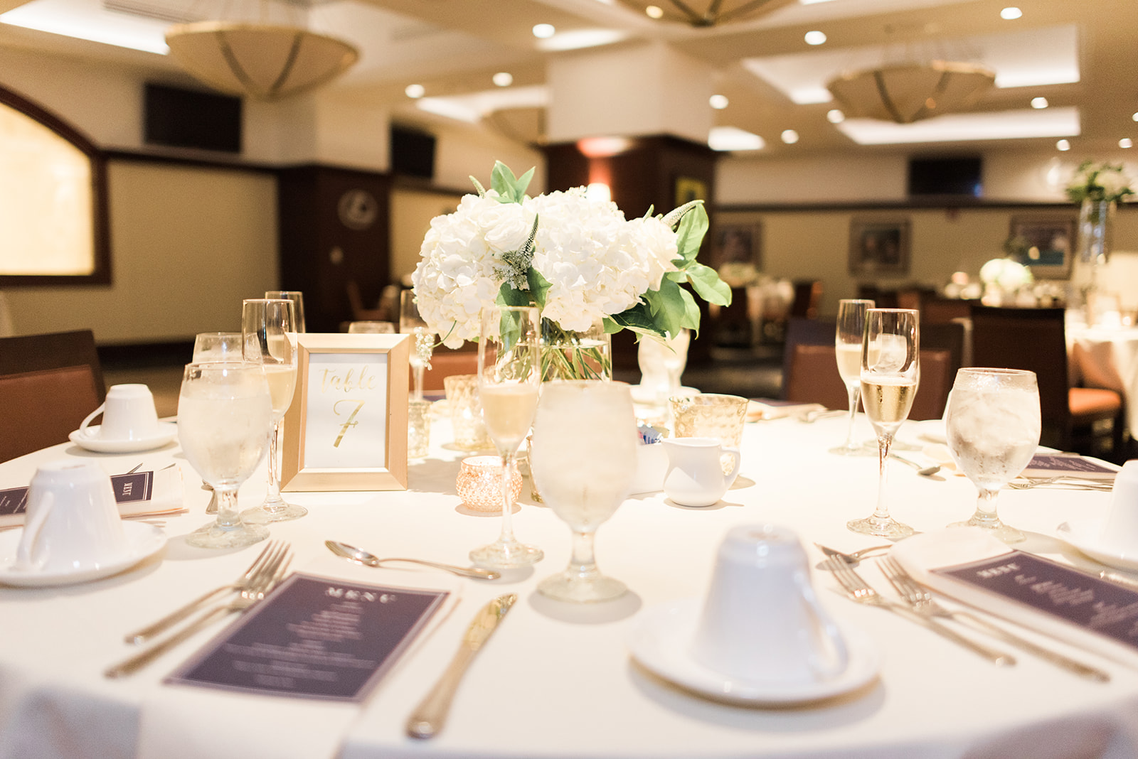 Wedding table decor for wedding reception with white floral centerpieces for Pittsburgh wedding at PNC Park planned by Exhale Events. Find more wedding inspiration at exhale-events.com!