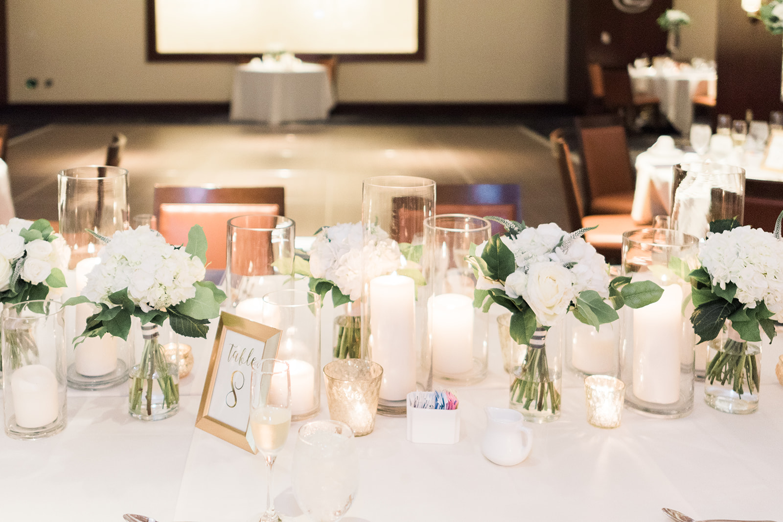 Wedding table decor for wedding reception with white floral centerpieces and candles for Pittsburgh wedding at PNC Park planned by Exhale Events. Find more wedding inspiration at exhale-events.com!