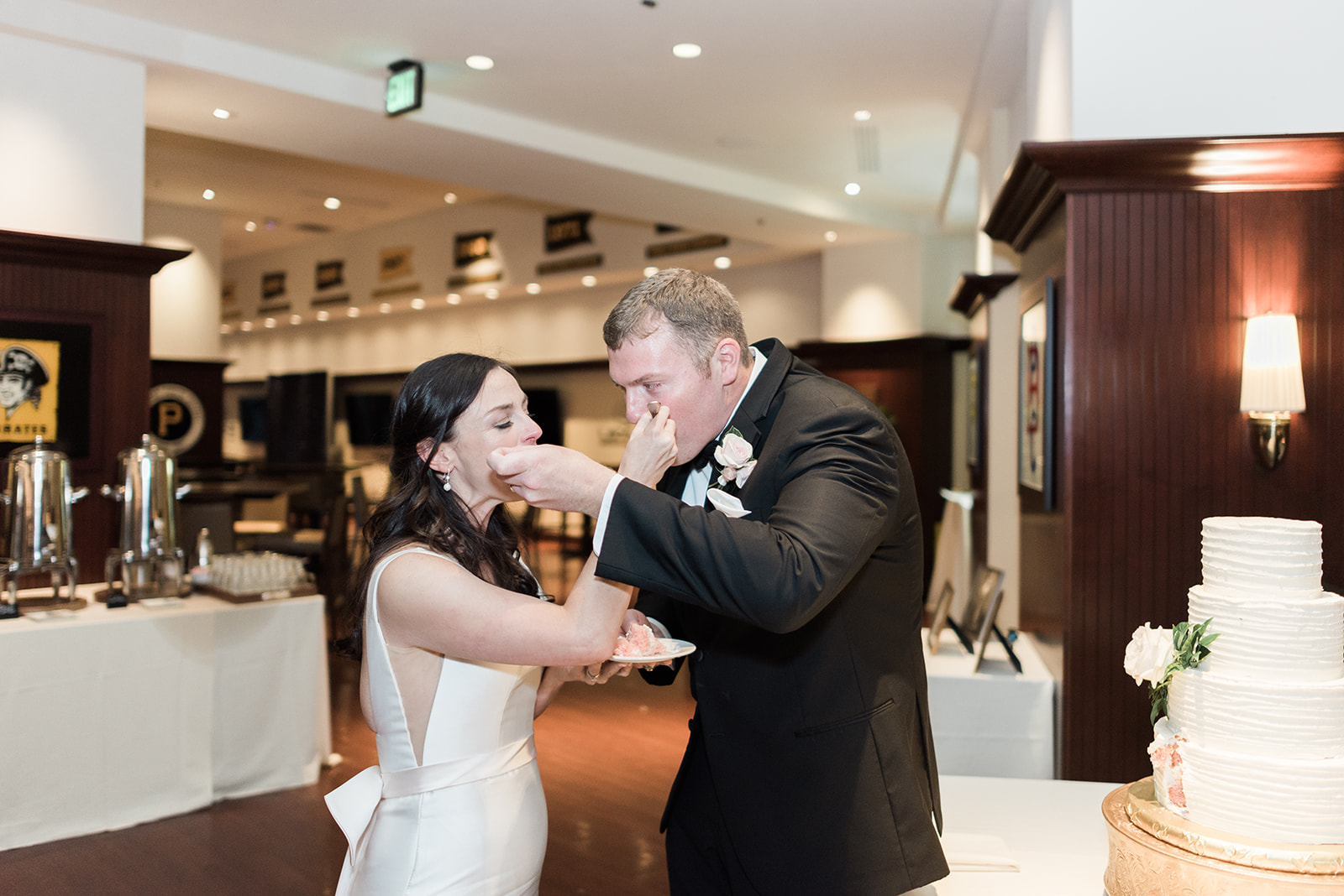 Bride and groom cut their wedding cake at Pittsburgh wedding at PNC Park planned by Exhale Events. Find more wedding inspiration at exhale-events.com!