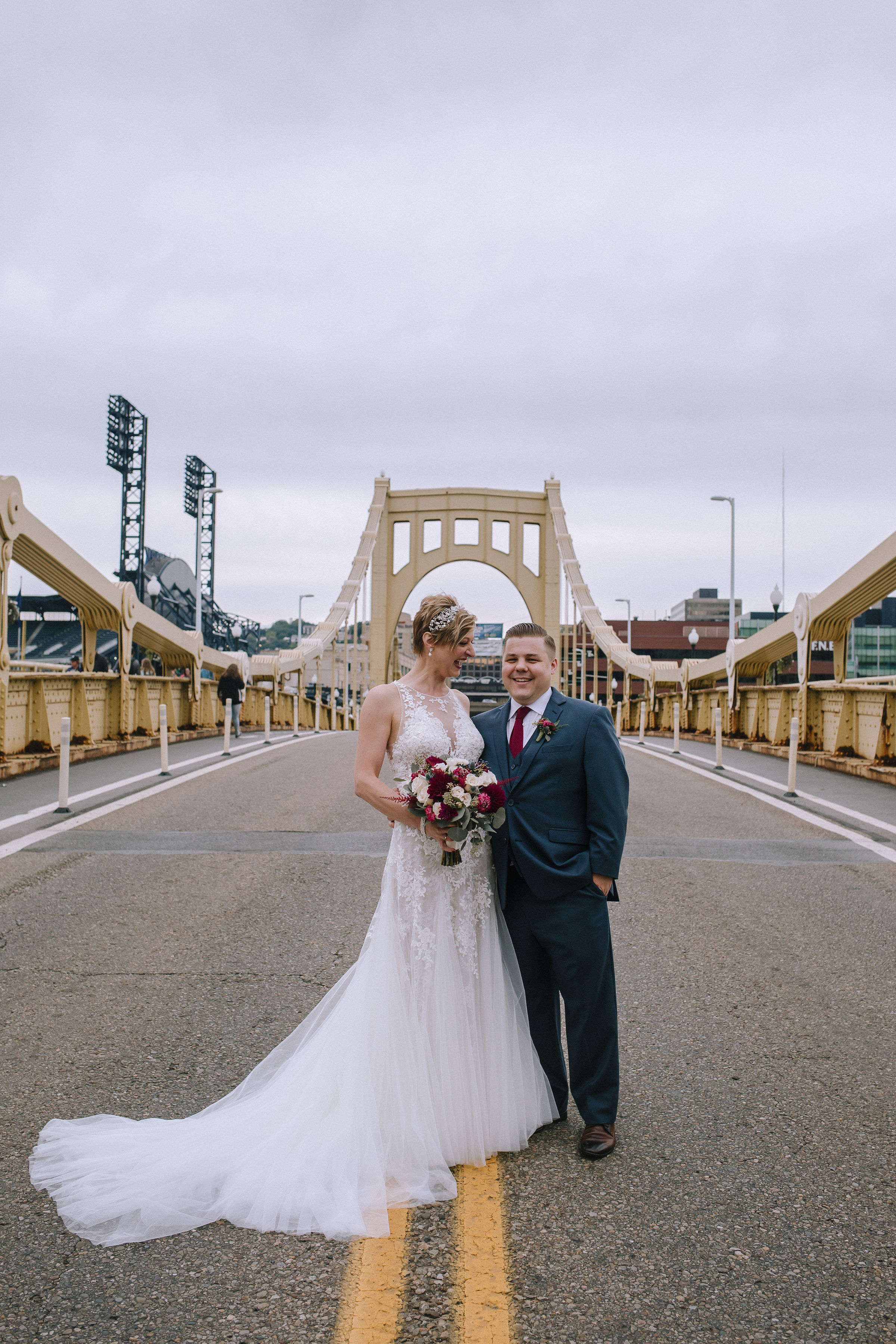 Bride and groom pose for wedding photos with wedding bouquet for Pittsburgh wedding at Studio Slate planned by Exhale Events. Find more wedding inspiration at exhale-events.com!