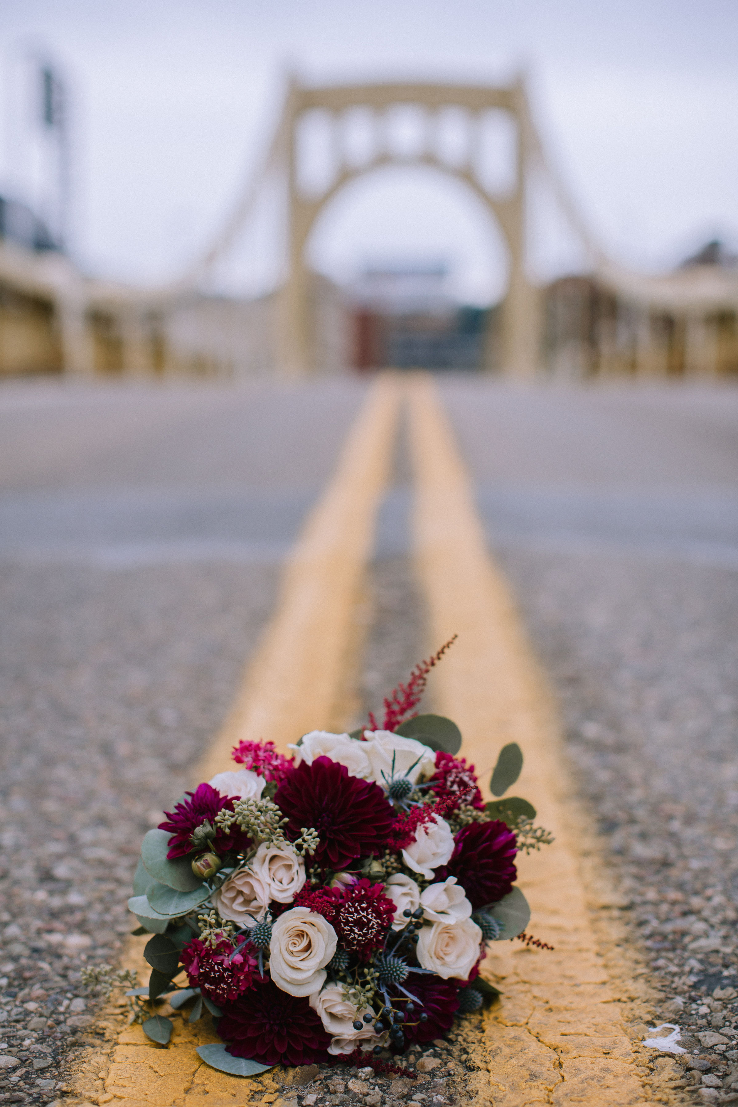 Wedding bouquet on city bridge for Pittsburgh wedding at Studio Slate planned by Exhale Events. Find more wedding inspiration at exhale-events.com!