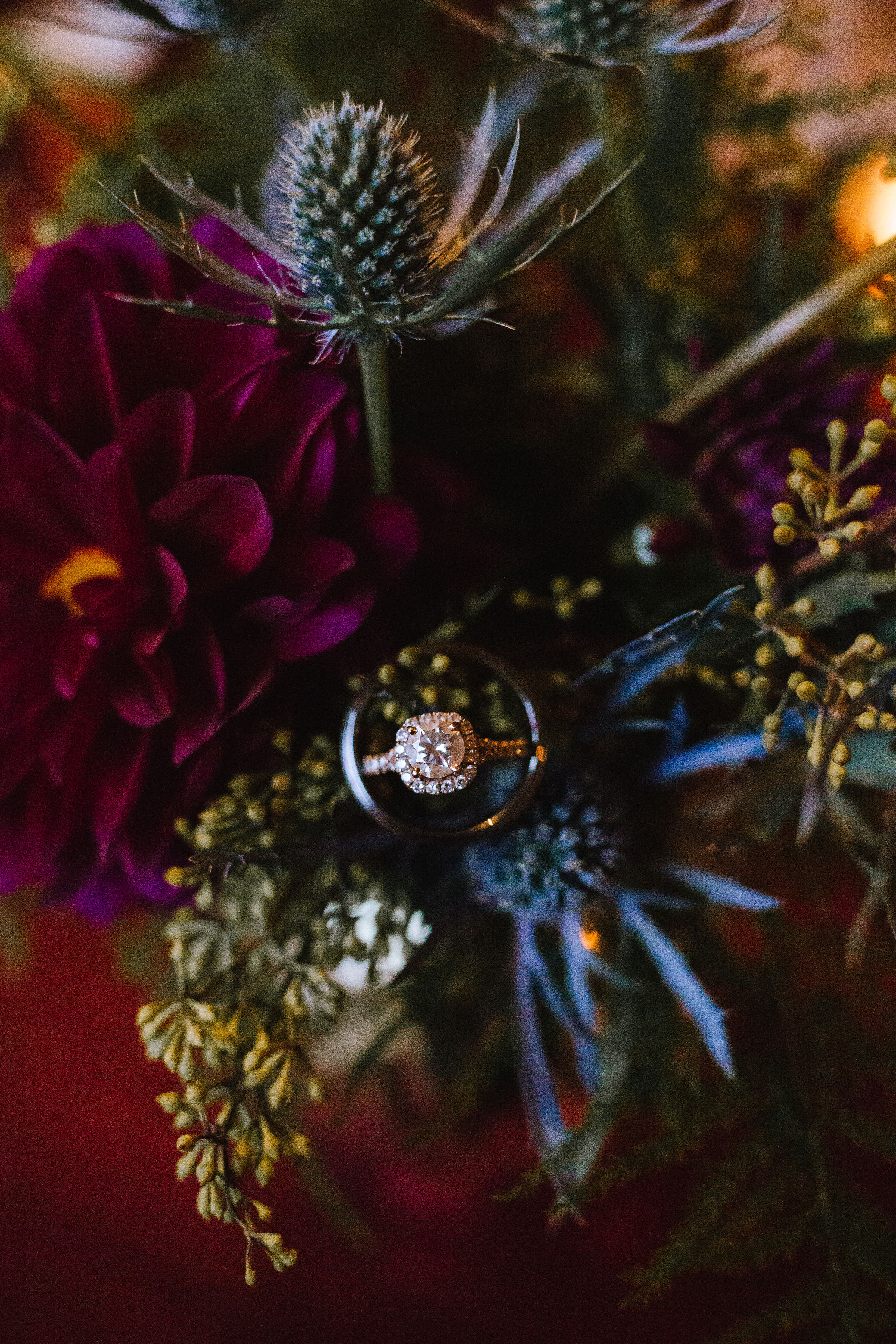 Wedding ring placed in wedding bouquet with blue thistle for Pittsburgh wedding at Studio Slate planned by Exhale Events. Find more wedding inspiration at exhale-events.com!