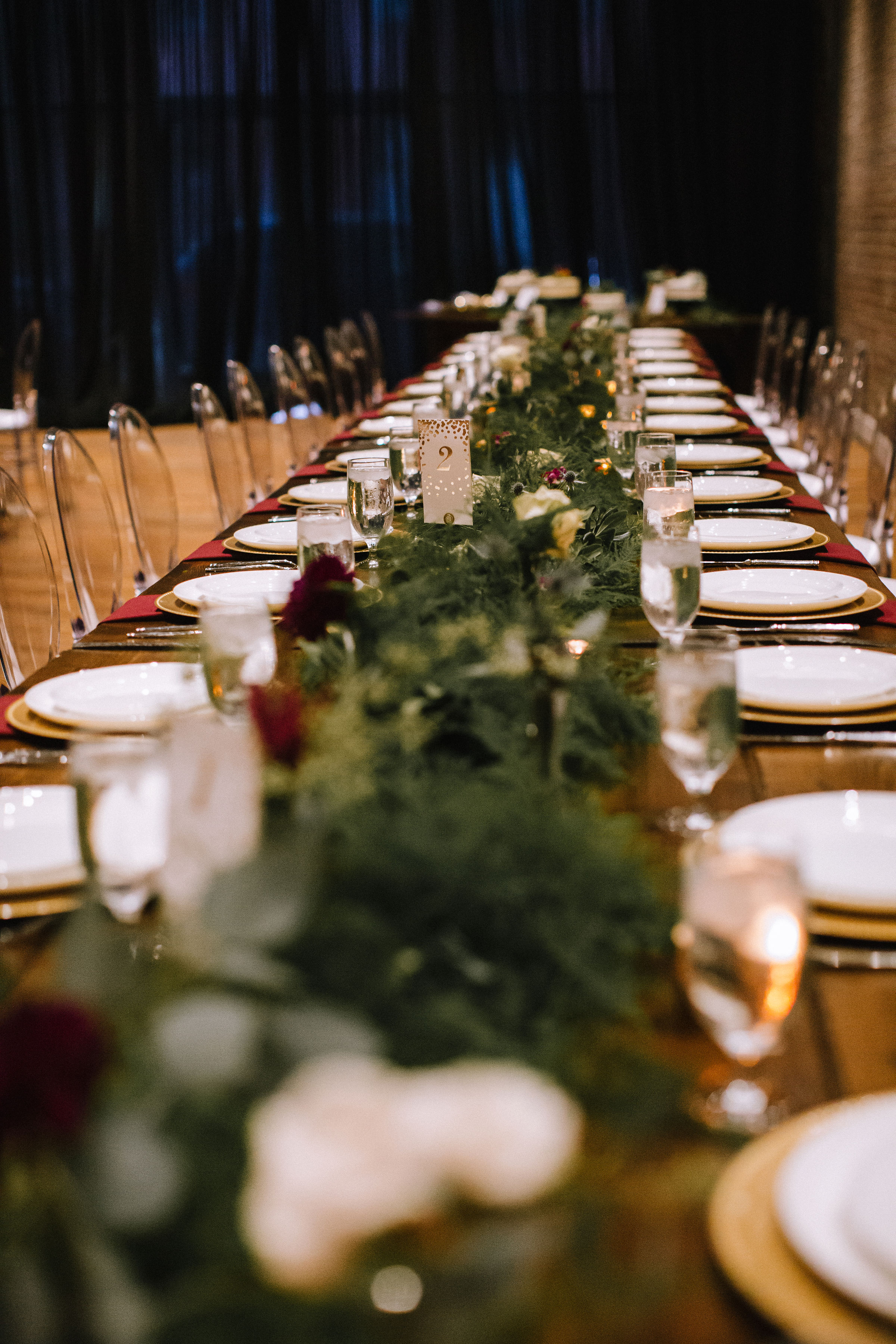 Wedding table decor with greenery and candles for Pittsburgh wedding at Studio Slate planned by Exhale Events. Find more wedding inspiration at exhale-events.com!