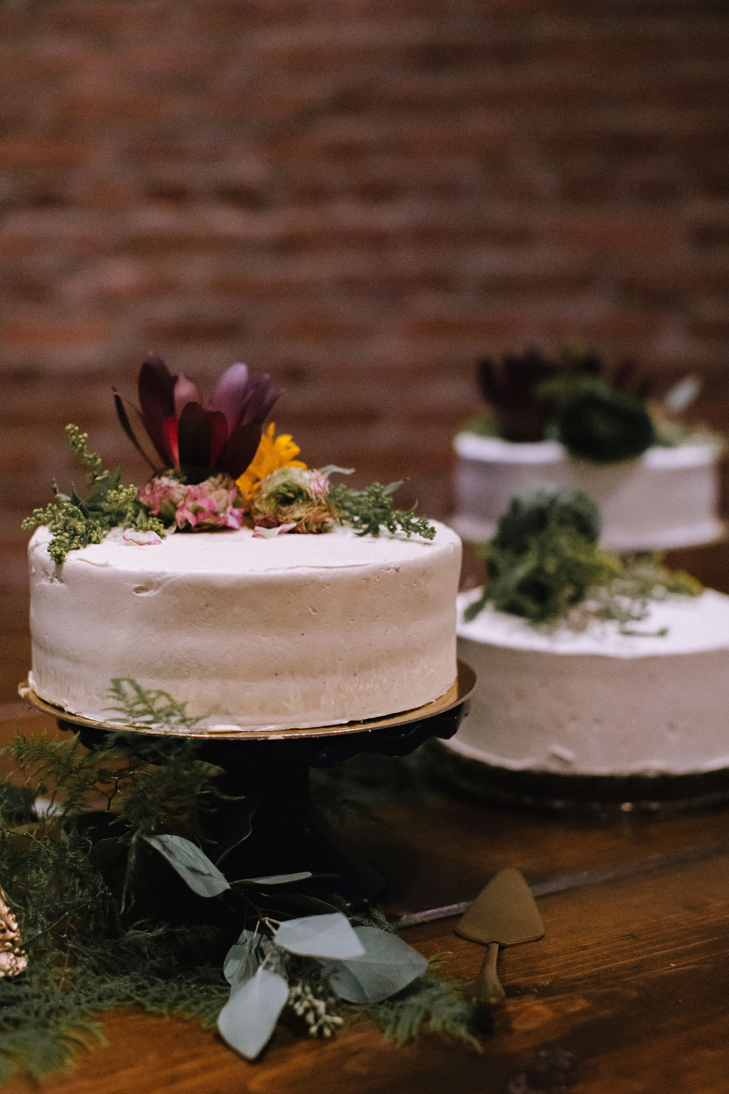 Multiple one tier wedding cakes for Pittsburgh wedding at Studio Slate planned by Exhale Events. Find more wedding inspiration at exhale-events.com!