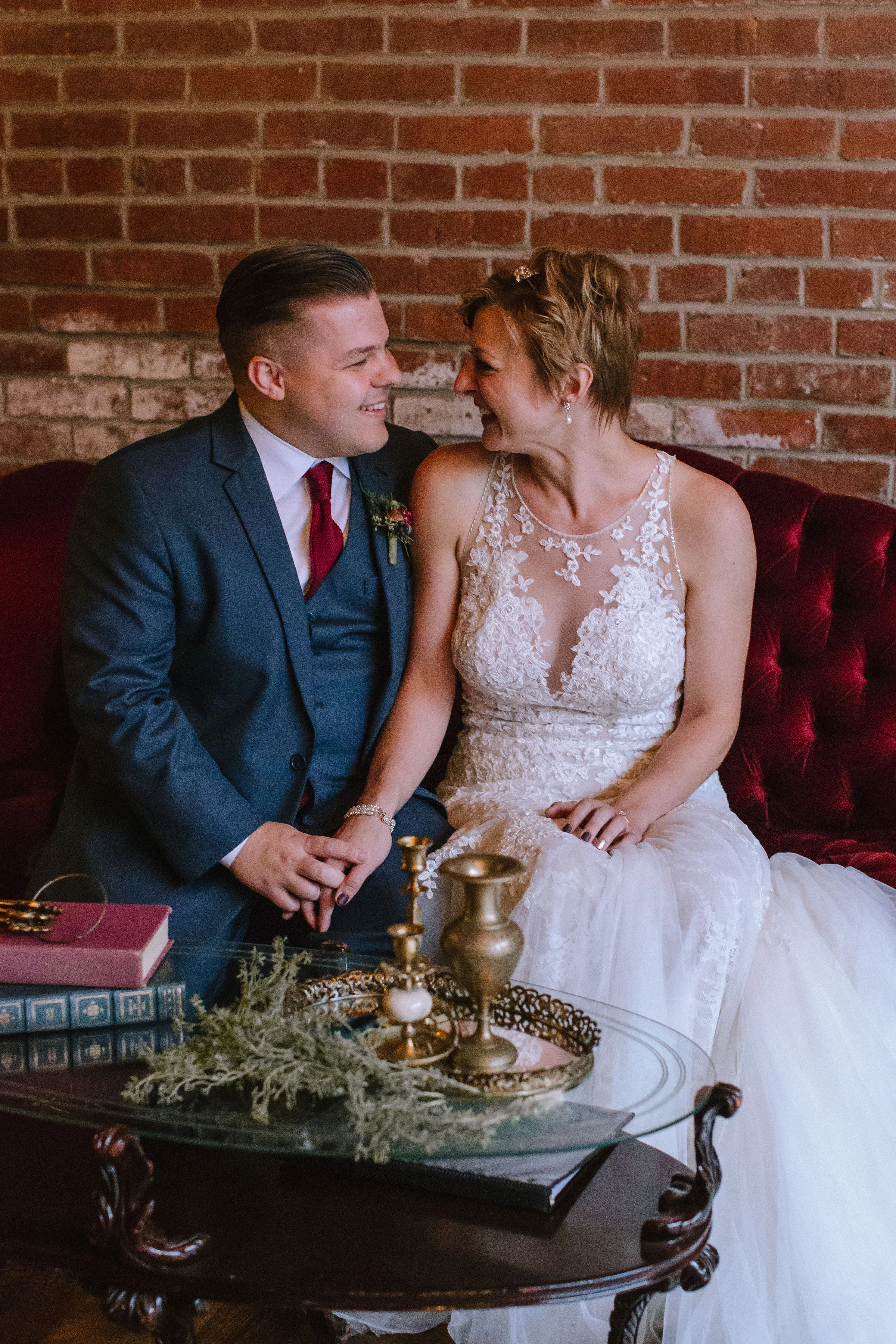 Slate Pittsburgh Wedding - Bride and groom pose with vintage decor for Pittsburgh wedding at Studio Slate planned by Exhale Events. Find more wedding inspiration at exhale-events.com