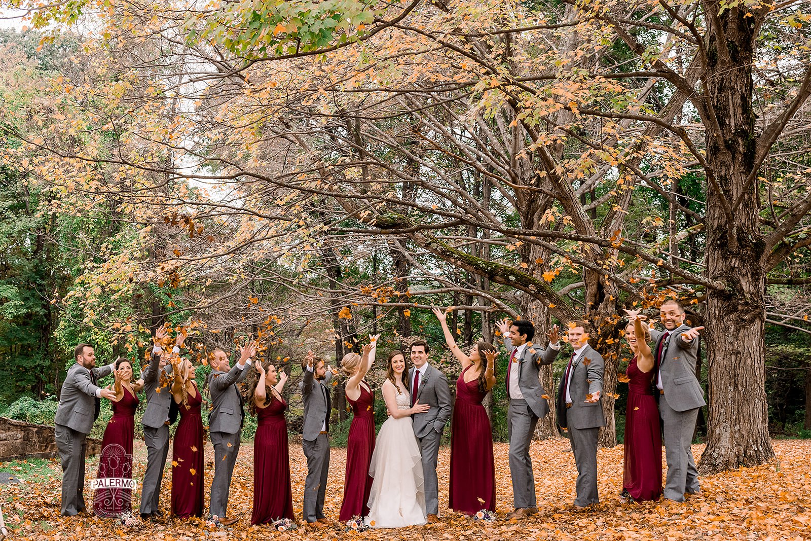 Wedding party poses for wedding photos with for burgundy fall barn wedding in Pittsburgh, PA planned by Exhale Events. Find more wedding inspiration at exhale-events.com!