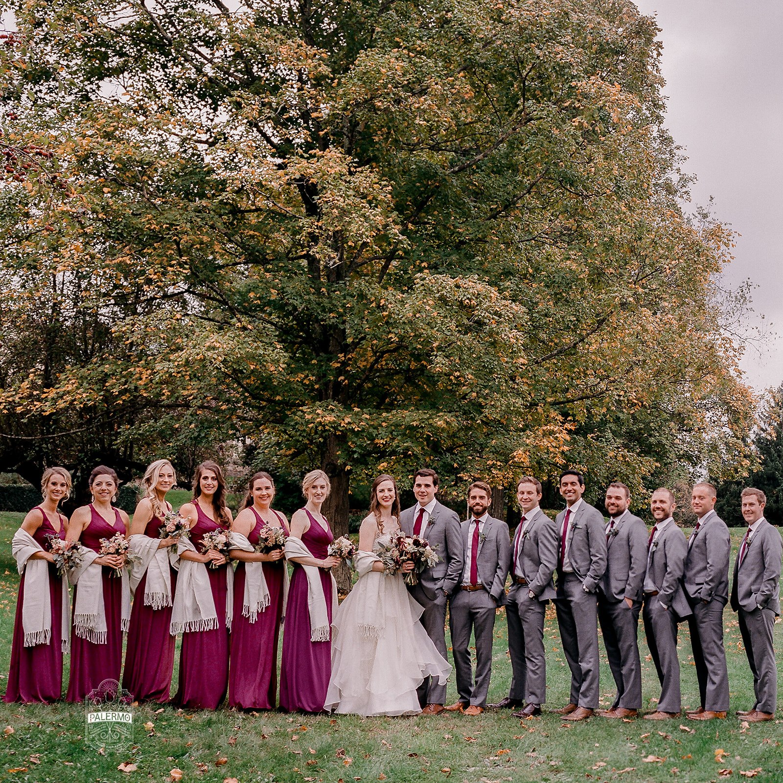 Wedding party poses for wedding photos with for burgundy fall barn wedding in Pittsburgh, PA planned by Exhale Events. Find more wedding inspiration at exhale-events.com!