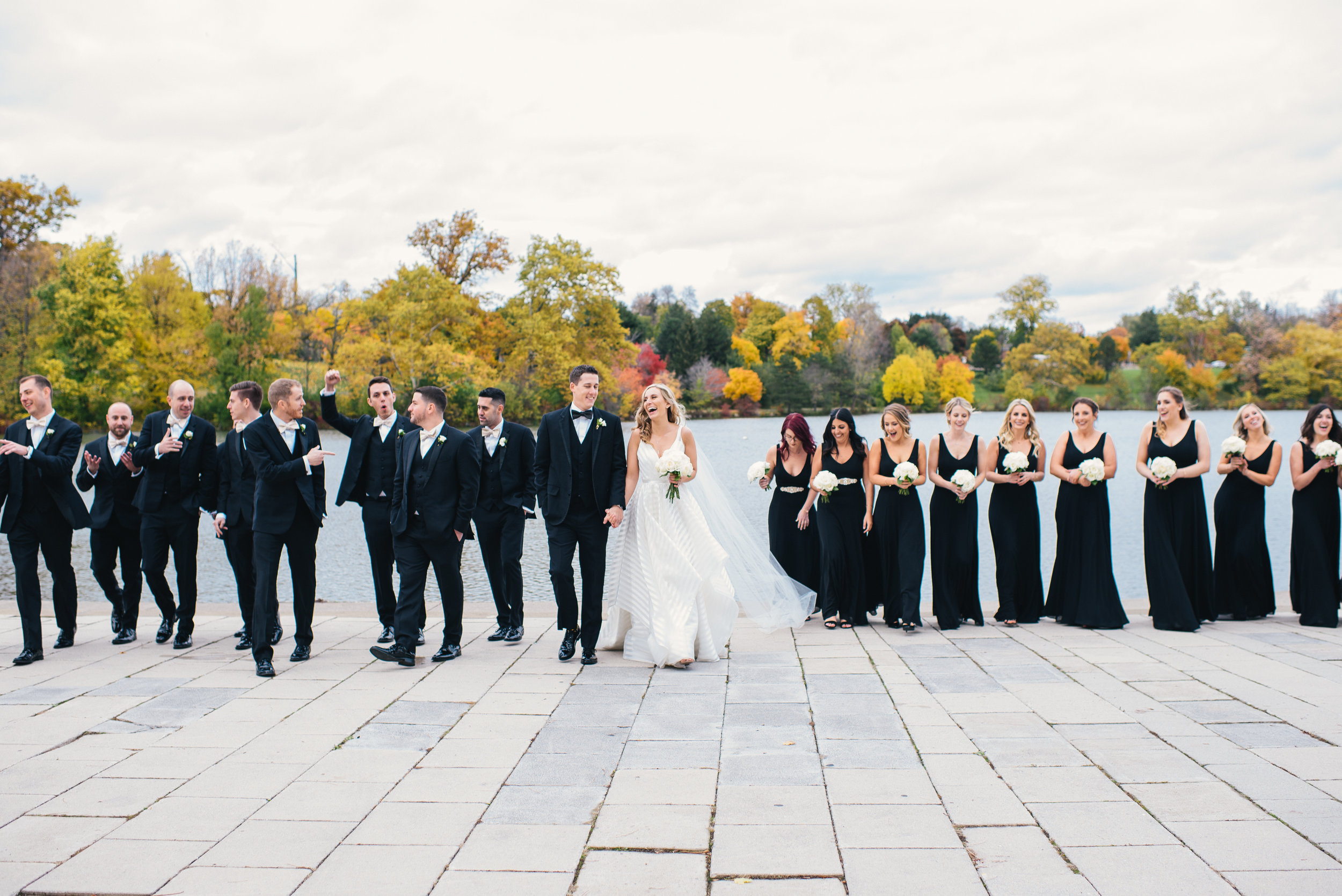 Bride and groom pose for outdoor wedding photos with wedding party for black, white, and gold wedding in Buffalo, NY planned by Exhale Events. Find more wedding inspiration at exhale-events.com!
