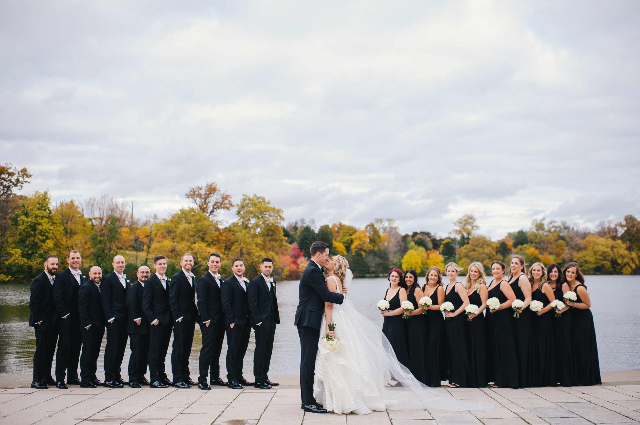 Bride and groom pose for outdoor wedding photos with wedding party for black, white, and gold wedding in Buffalo, NY planned by Exhale Events. Find more wedding inspiration at exhale-events.com!