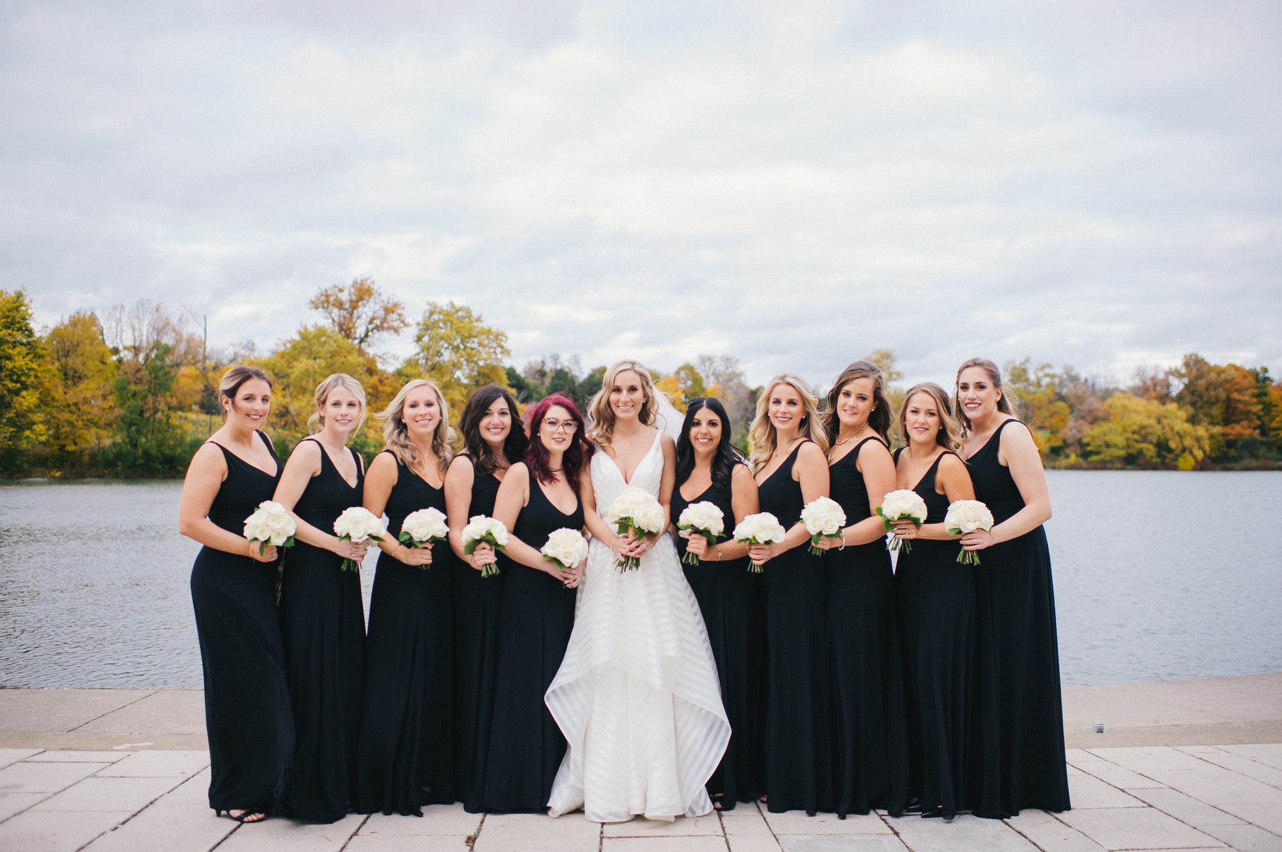 Black bridesmaids dresses and white wedding bouquets for black, white, and gold wedding in Buffalo, NY planned by Exhale Events. Find more wedding inspiration at exhale-events.com!