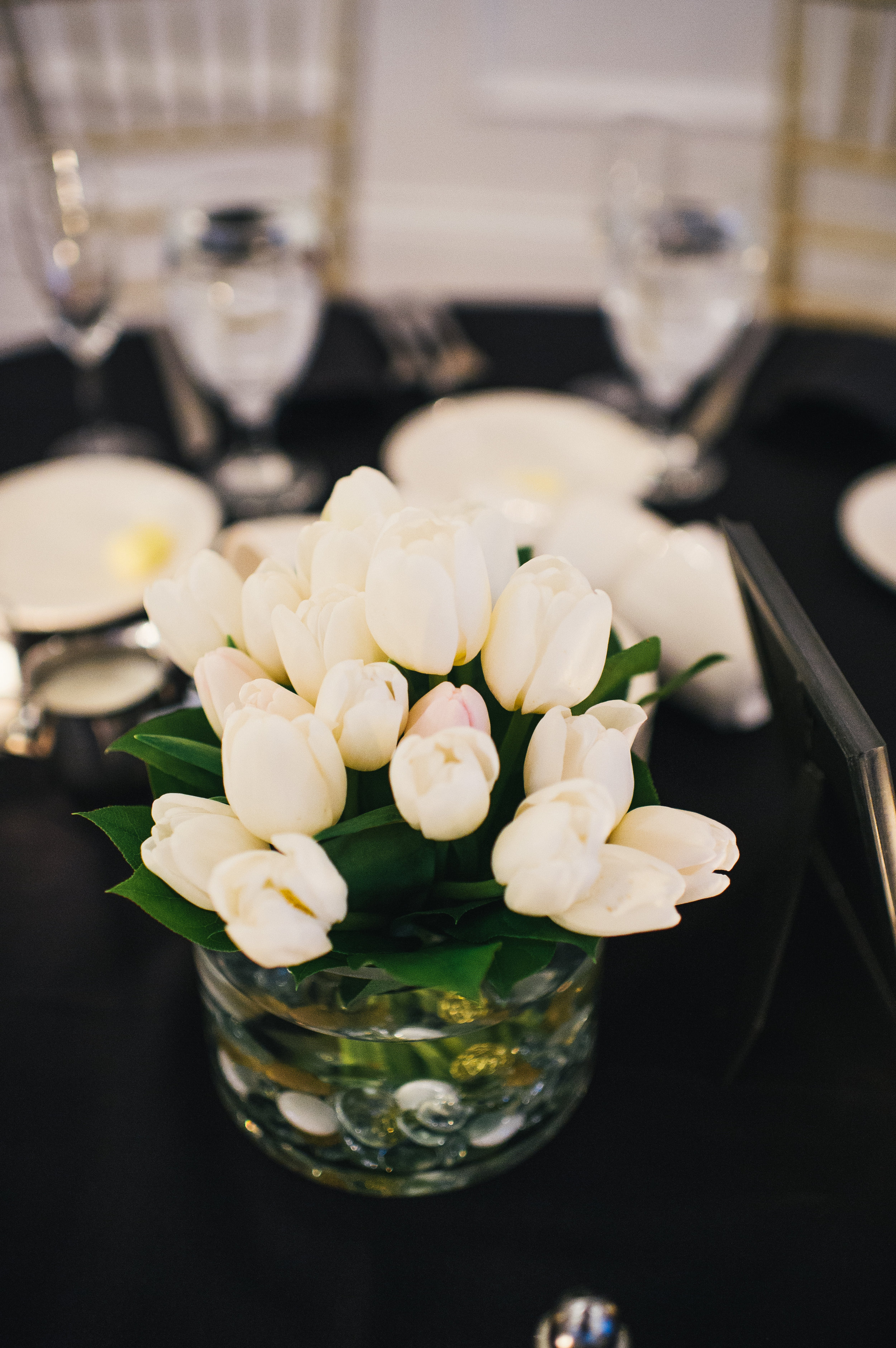 White wedding flower centerpieces for black, white, and gold wedding in Buffalo, NY planned by Exhale Events. Find more wedding inspiration at exhale-events.com!