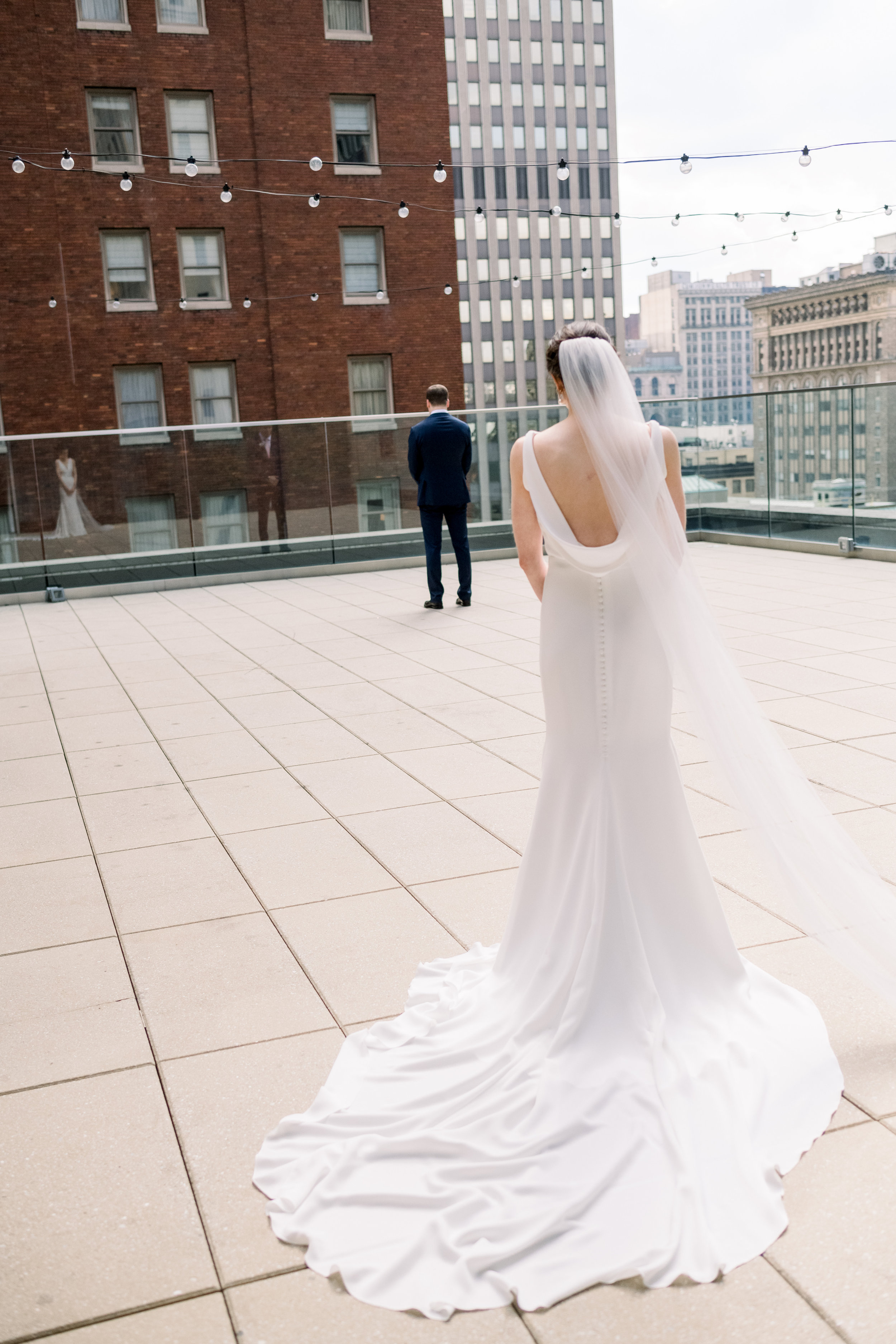 Bride and groom share first look for Pittsburgh wedding at Hotel Monaco planned by Exhale Events. Find more modern wedding ideas at exhale-events.com!