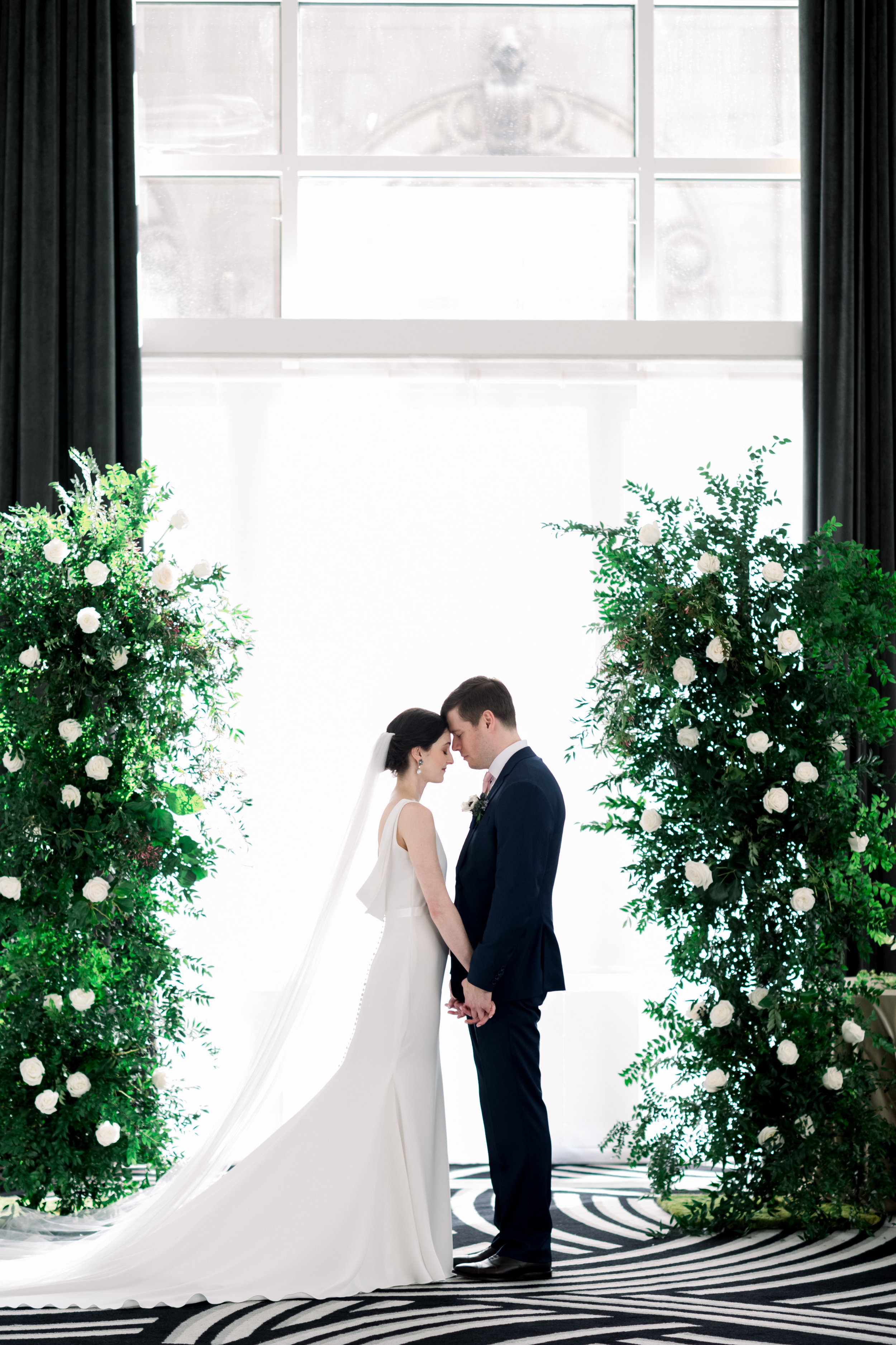 Bride and groom pose for wedding photos for Pittsburgh wedding at Hotel Monaco planned by Exhale Events. Find more modern wedding ideas at exhale-events.com!