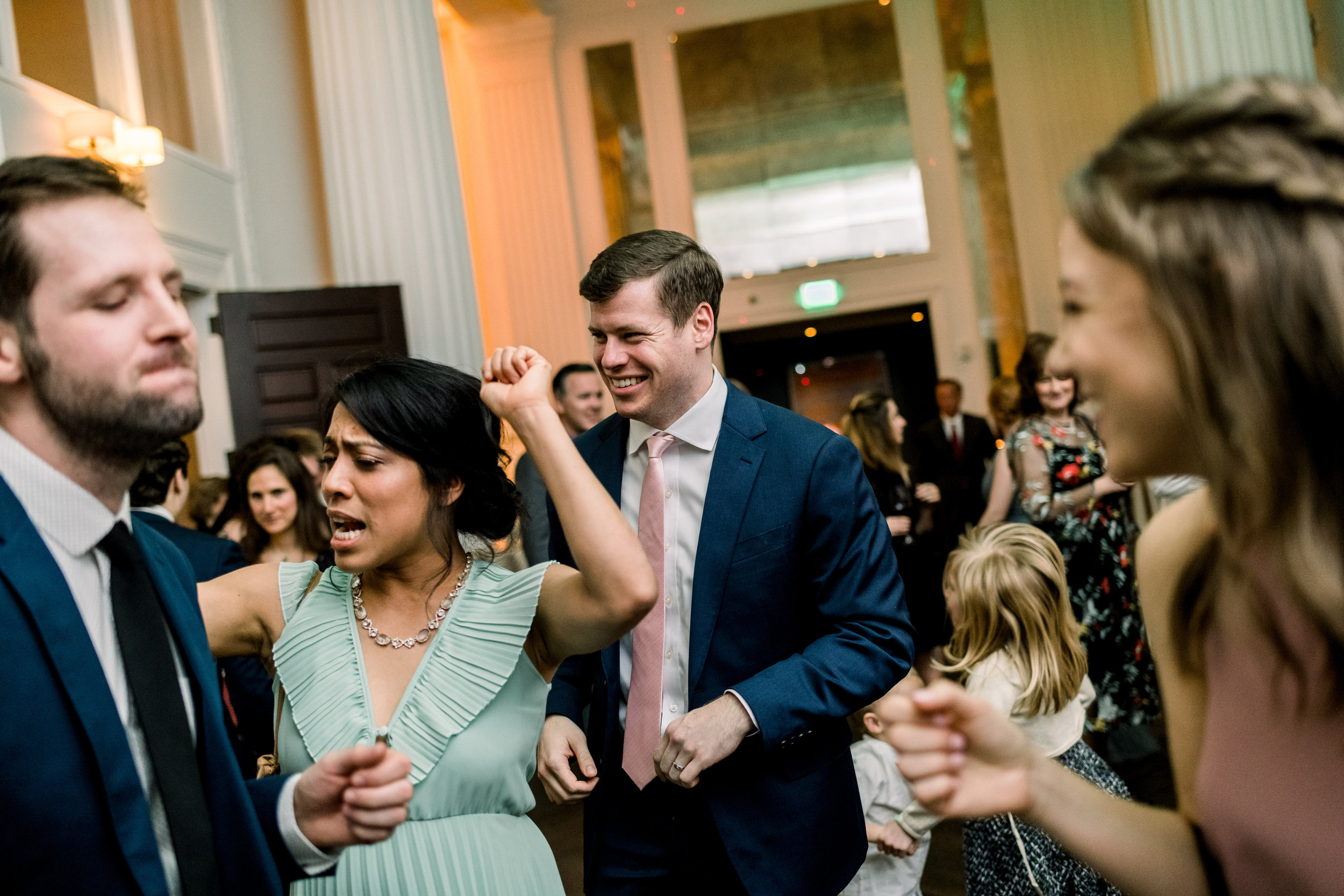 Bride and groom dancing with guests at Pittsburgh wedding at Hotel Monaco planned by Exhale Events. Find more modern wedding ideas at exhale-events.com!