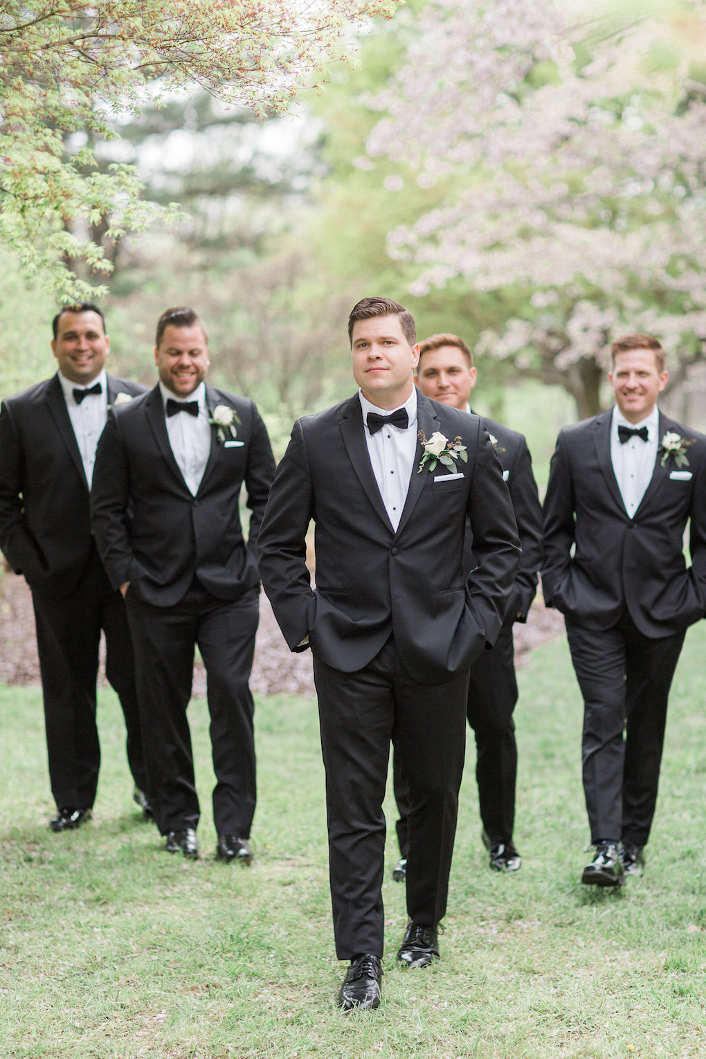 Groom and groomsmen pose for wedding photos for chic wedding in Buffalo, NY planned by Exhale Events. Find more timeless wedding inspiration at exhale-events.com!