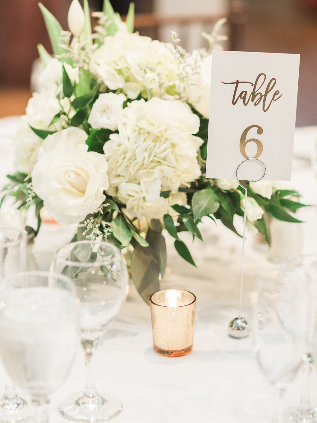White and greenery wedding centerpieces for chic wedding in Buffalo, NY planned by Exhale Events. Find more timeless wedding inspiration at exhale-events.com!