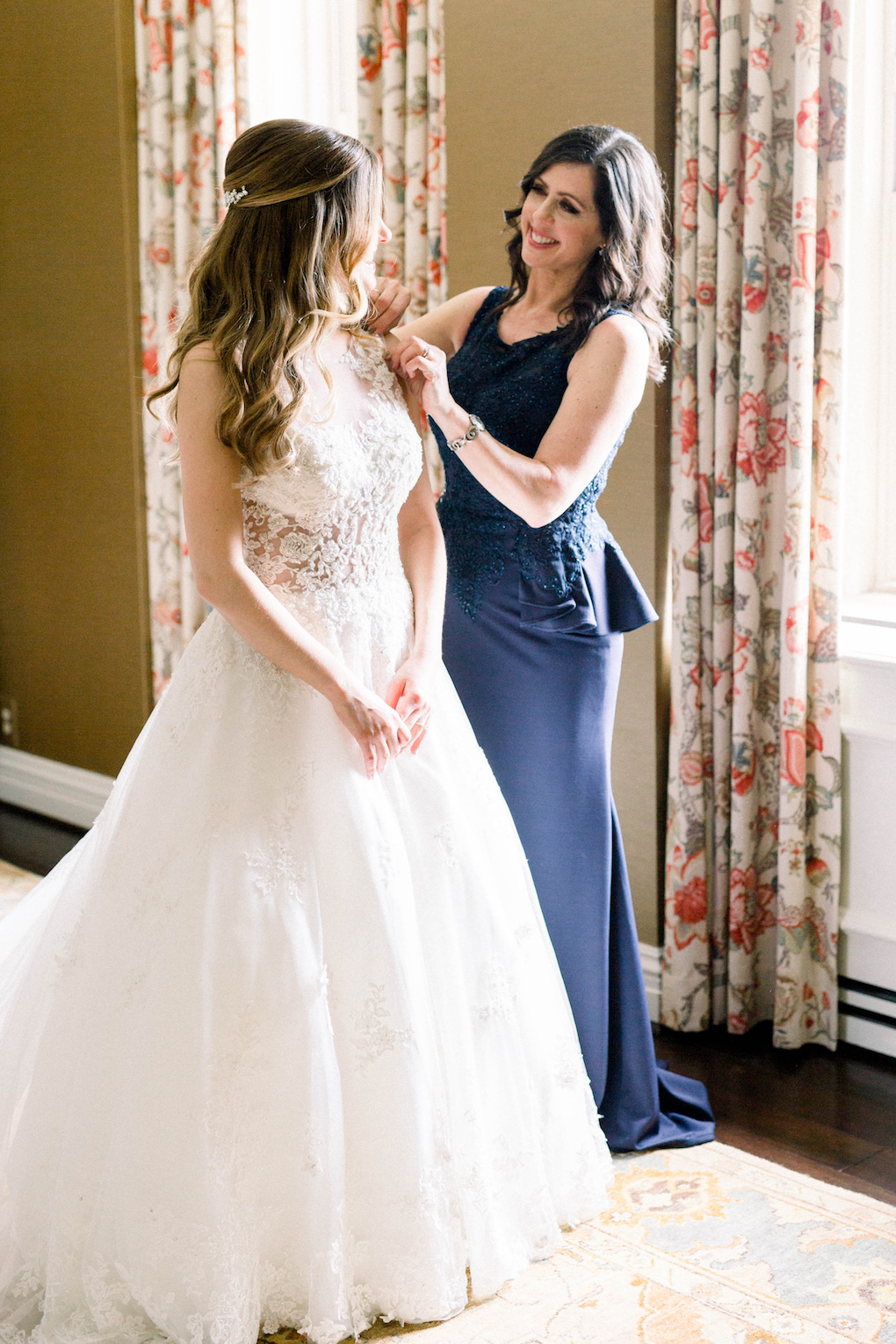 Bride getting into wedding dress: Romantic Fairytale wedding at the Omni William Penn in Pittsburgh, PA planned by Exhale Events. Find more wedding inspiration at exhale-events.com!