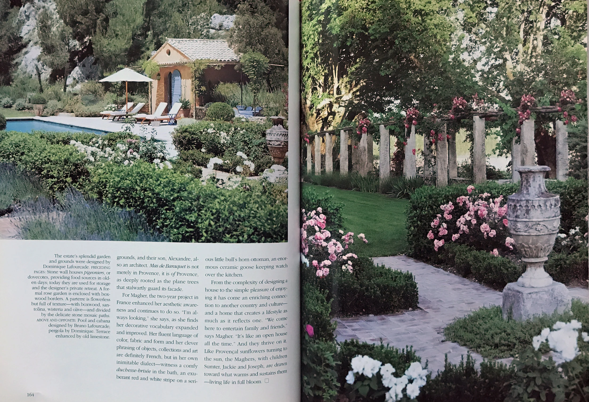 French gardens with roses and boxwood near pool.
