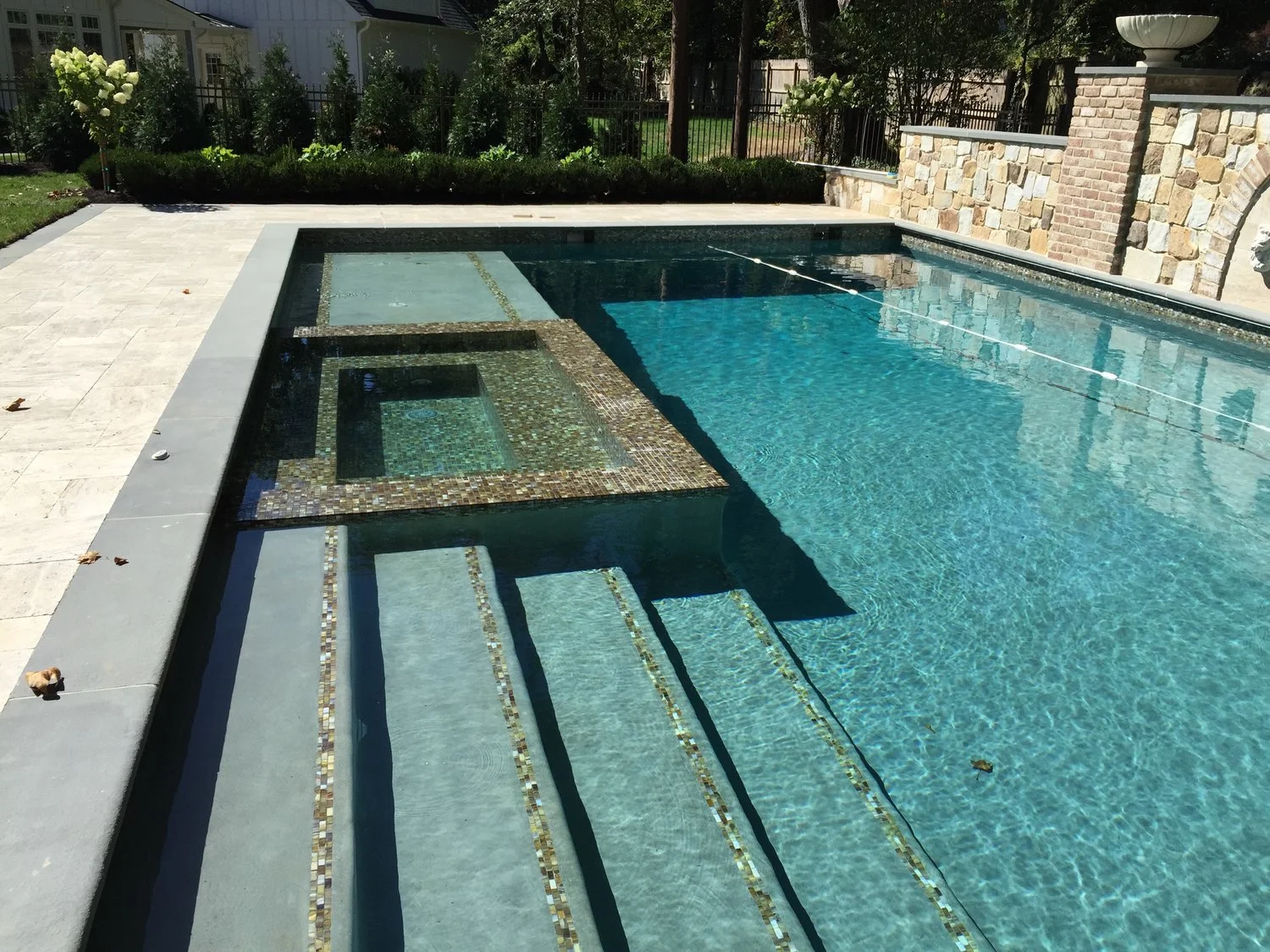 25' x 45' pool with grand entry steps - all glass tile interior spa - blue stone coping - travertine patio