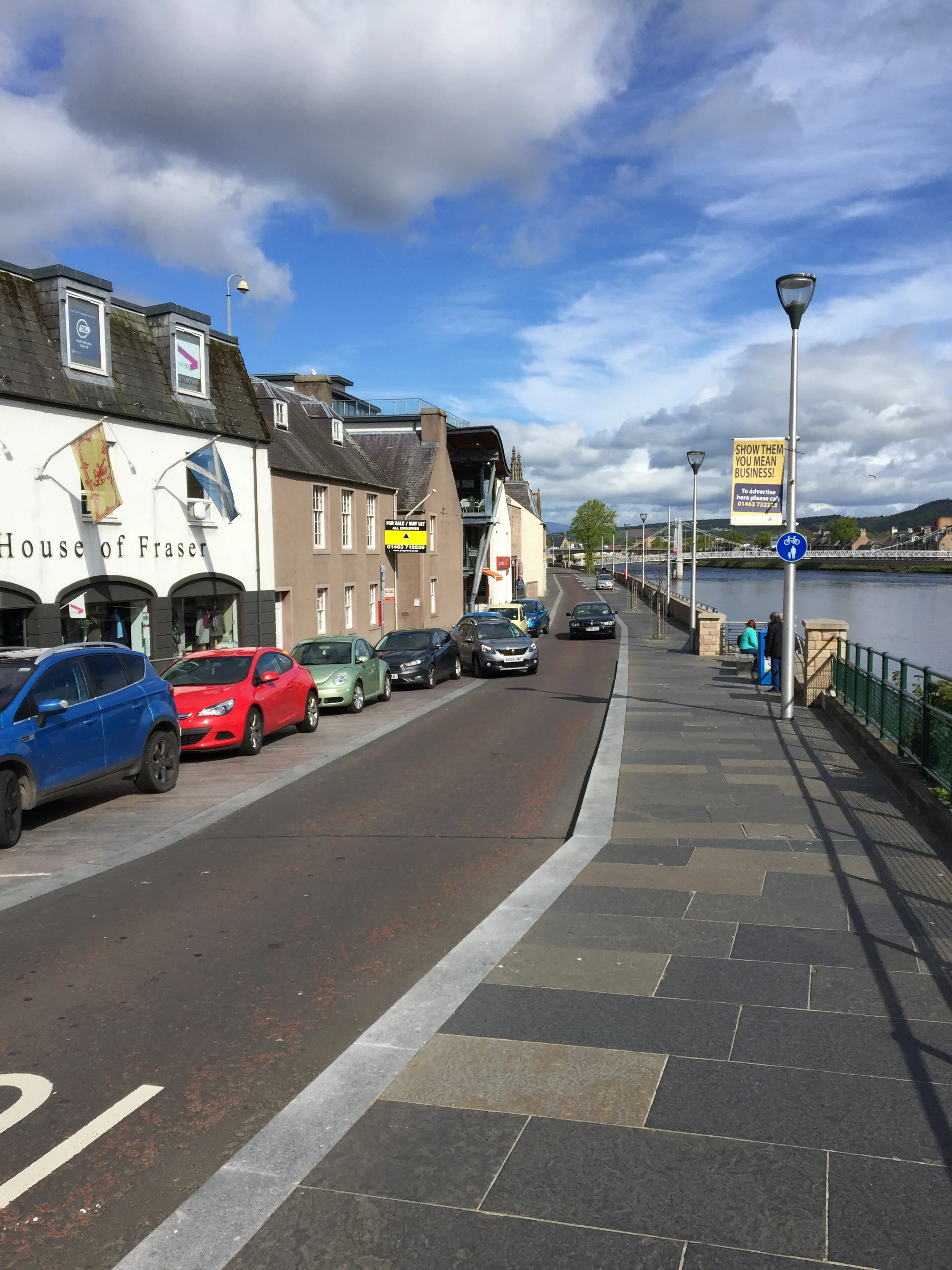 An Inverness street. Visible not physical barriers between pedestrians and motorists