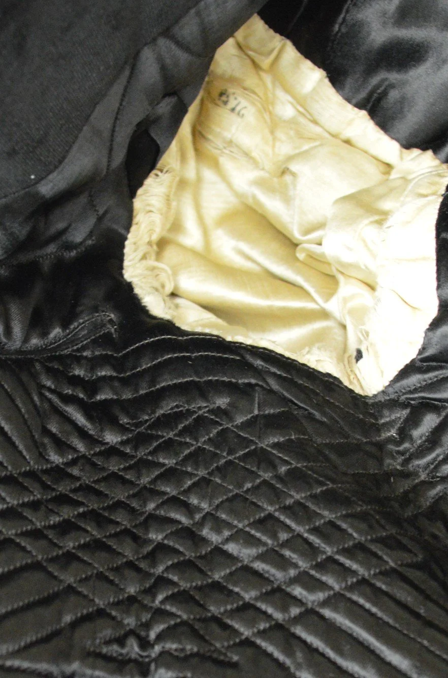 An interior view of the FRC tailcoat, where close stitching in a crossed diagonal pattern is visible on the underarm lining.