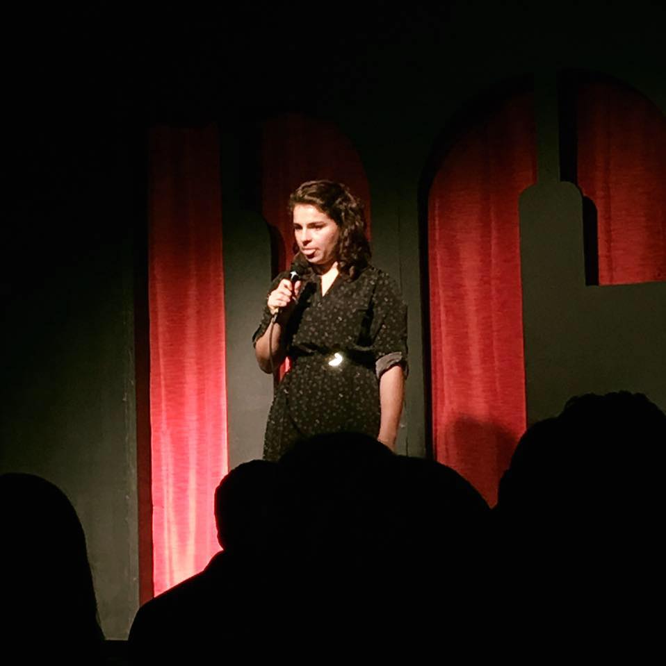 Devon Kodzis telling a story onstage. 