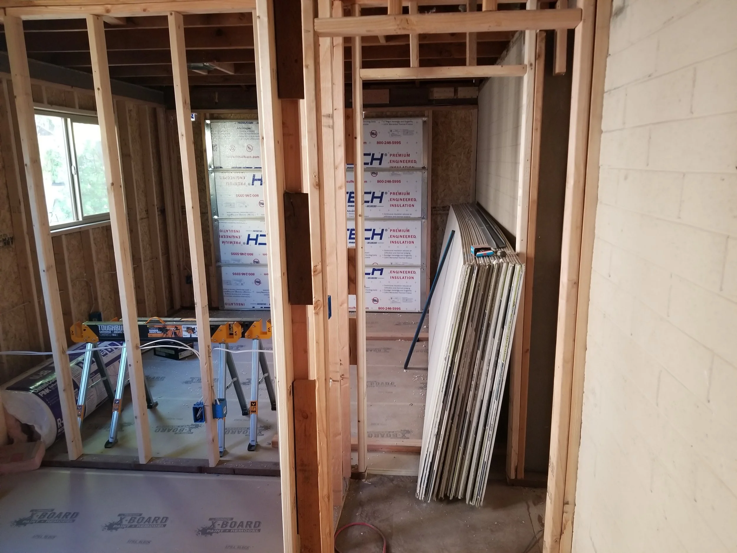 Electric in, insulation next, then drywall