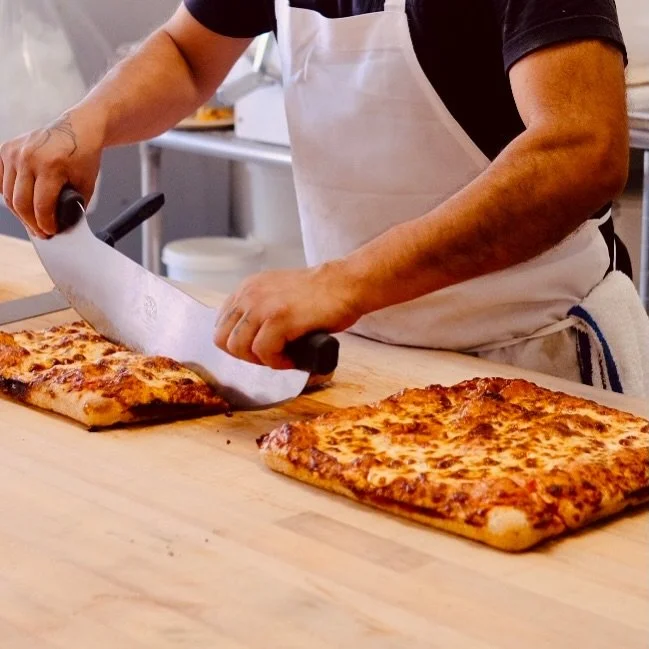 Friday dinner is handled.

Our focaccia pizzas are available by preorder for Friday pickup &mdash; old-school Sicilian style with a crispy focaccia base, bubbly mozzarella, and really good toppings.

Choose from Classic Cheese, Pepperoni, Greek, or T