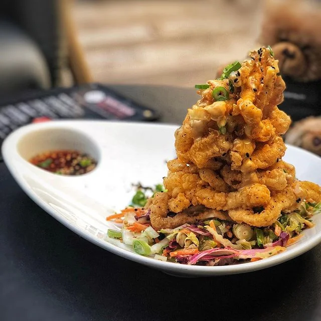 crispy asian calamari tower |🦑| tonight, funky buddha will be at tap 42 aventura for their first public pour and release party. get a first taste of their new brew! | #themiamimenu #tap42