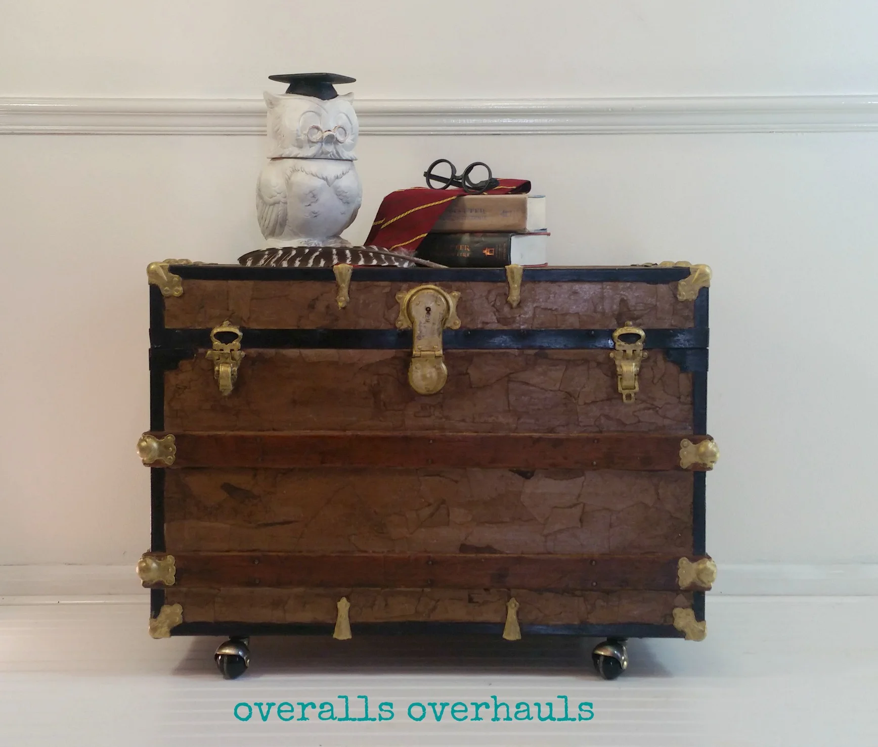 This is the finished product. Replaced the old really rusty built-in wheels with these casters. Refinished bits of wood, hardware and metal and adding a faux leather finish. I think it's adorable! Good for a coffee table - store games inside, end table, night stand or at the foot of a bed. 