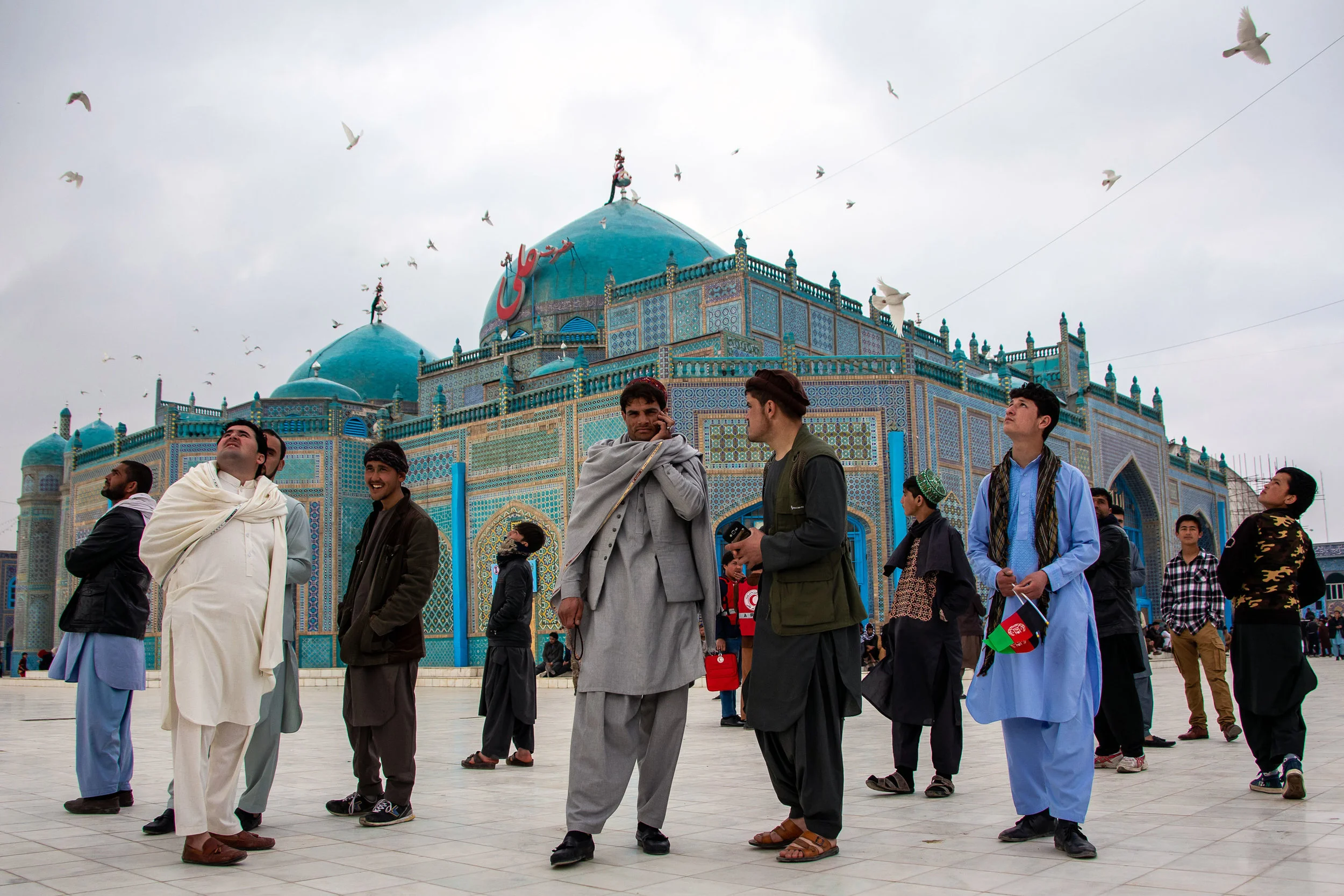 A security helicopter flying just overhead scares a flock of birds over Mazar-e Sharif’s blue mosque during the Nowruz celebrations.