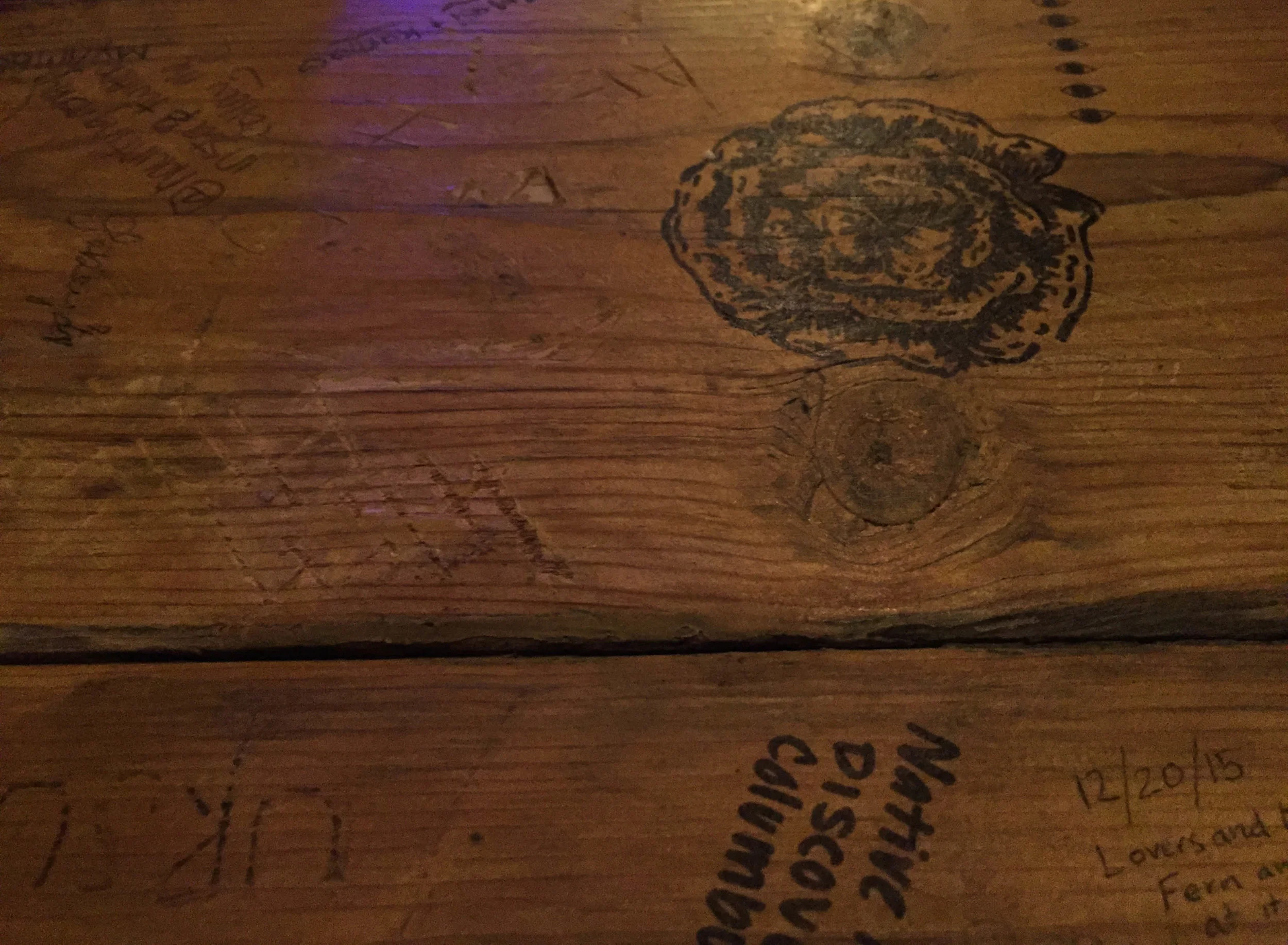  Graffiti adorns the wooden tables at Melt, an ice cream shop in downtown Phoenix.&nbsp; 