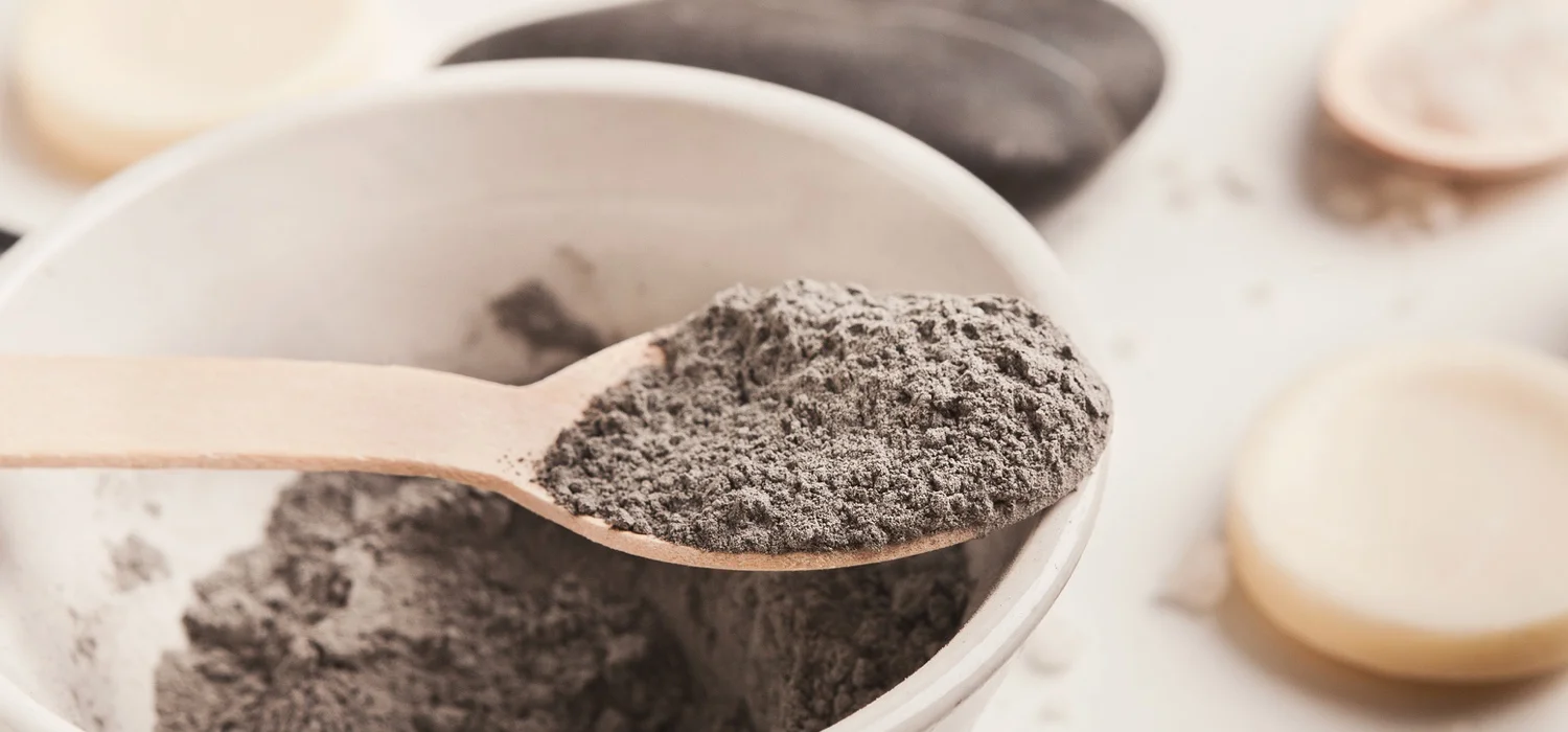 Bentonite-Clay-bath-salts-dry-skin-brush-on-table-at-home.jpg