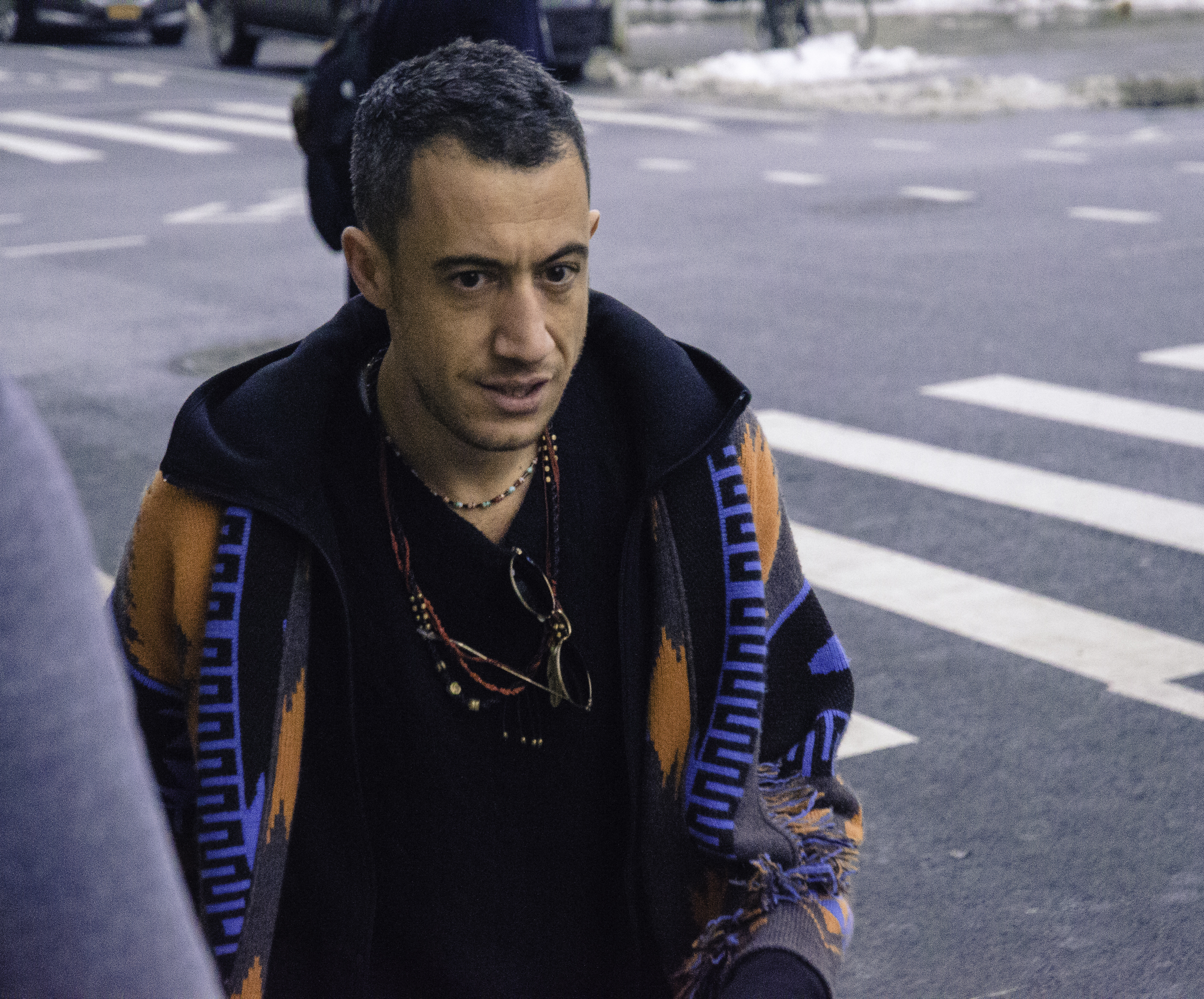 This guy knows his hoodie is the main colour-contributor to his outfit. He therefore wore a simple black sweater underneath the hoodie with tamed accessories around his neck to establish a balance